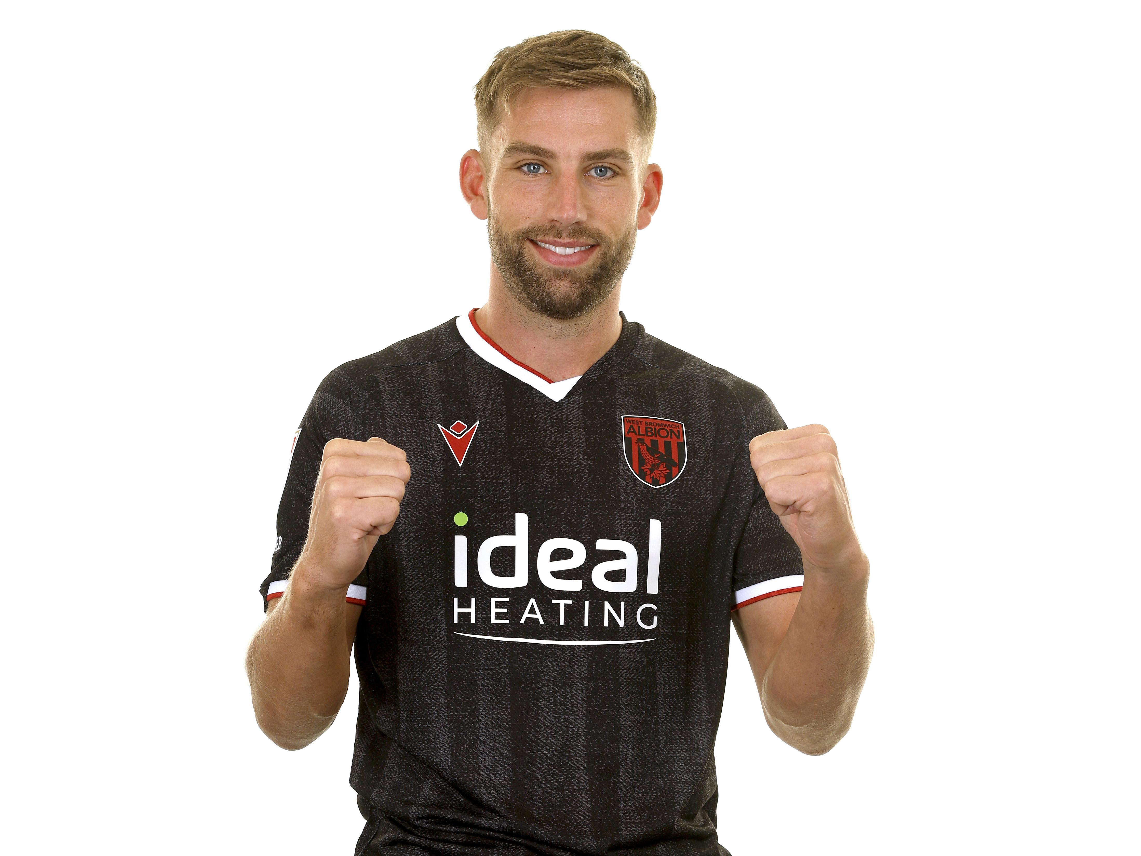Charlie Taylor smiling at the camera while wearing the black away kit 