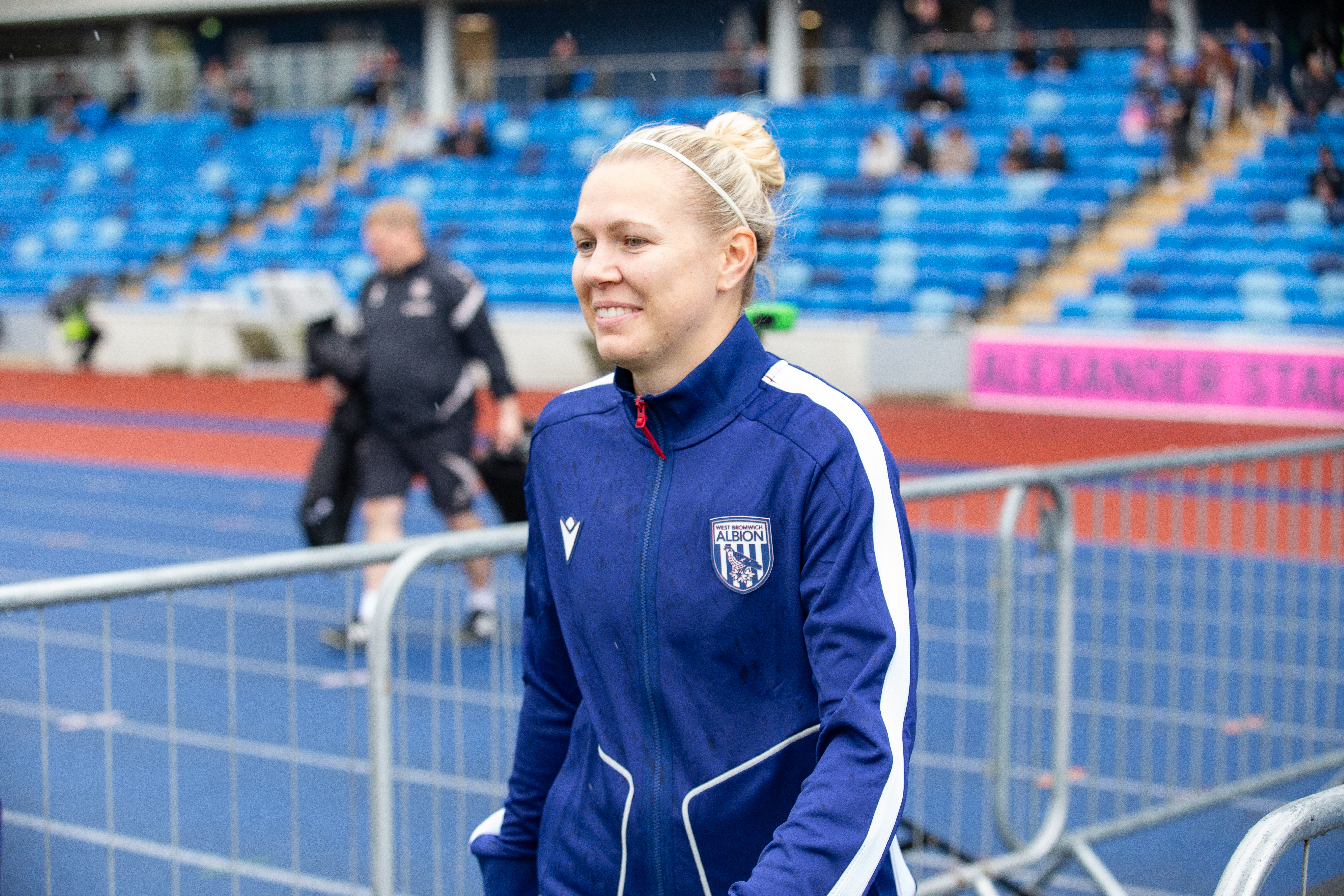 Hannah George smiling while walking out of the tunnel at the Alexander Stadium