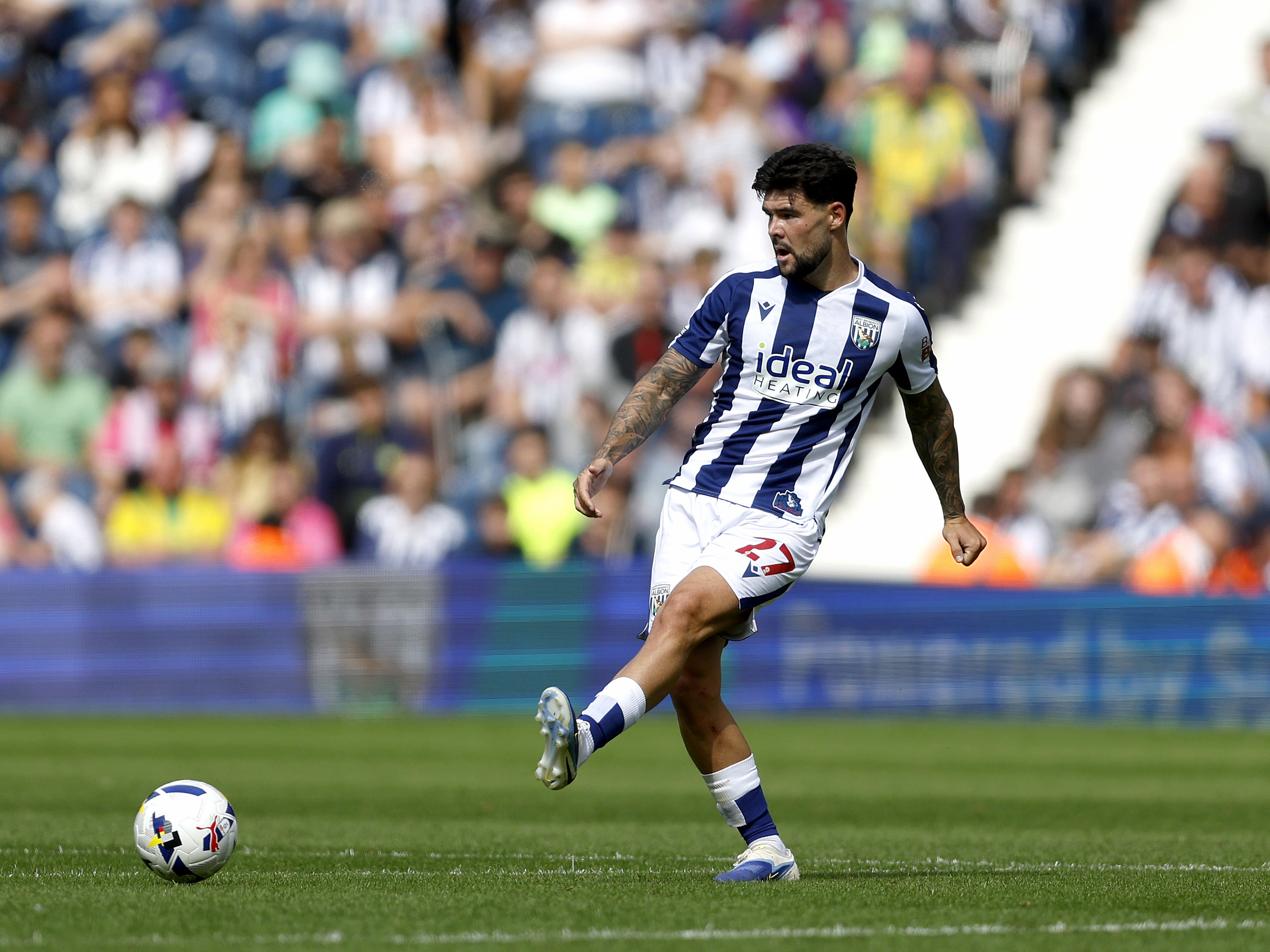 A photo of Alex Mowatt in action against Portsmouth wearing the 2025/26 home kit