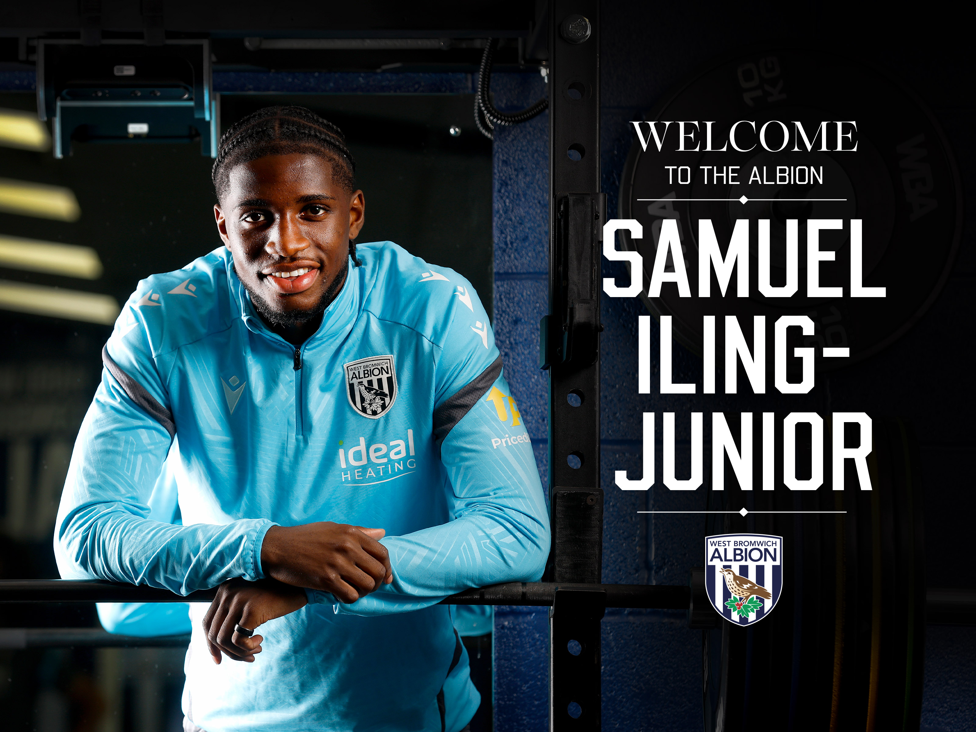 Samuel Iling-Junior smiling at the camera while stood in the gym leaning on a bar
