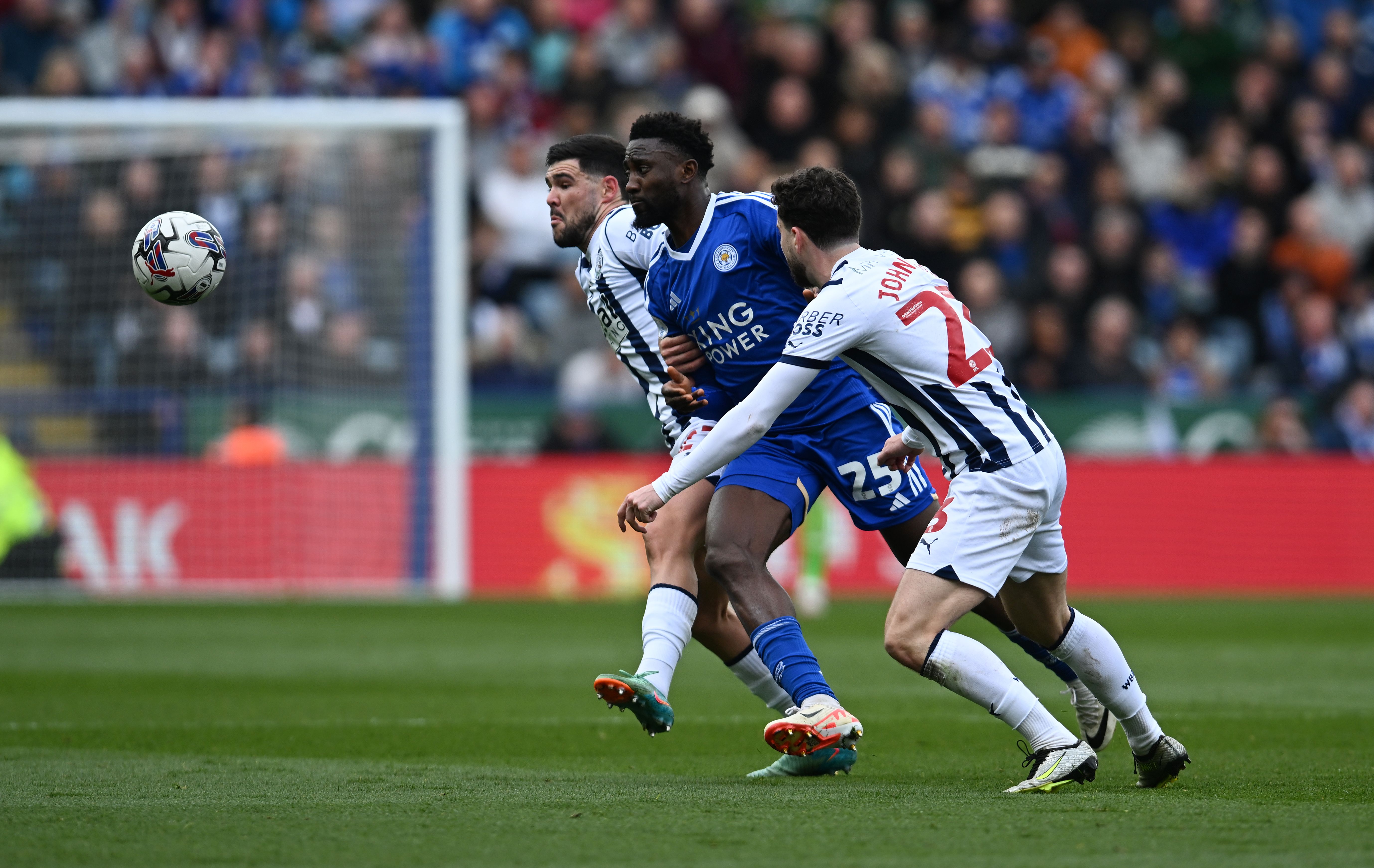 Alex Mowatt and Mikey Johnston fight for the ball with a Leicester player 