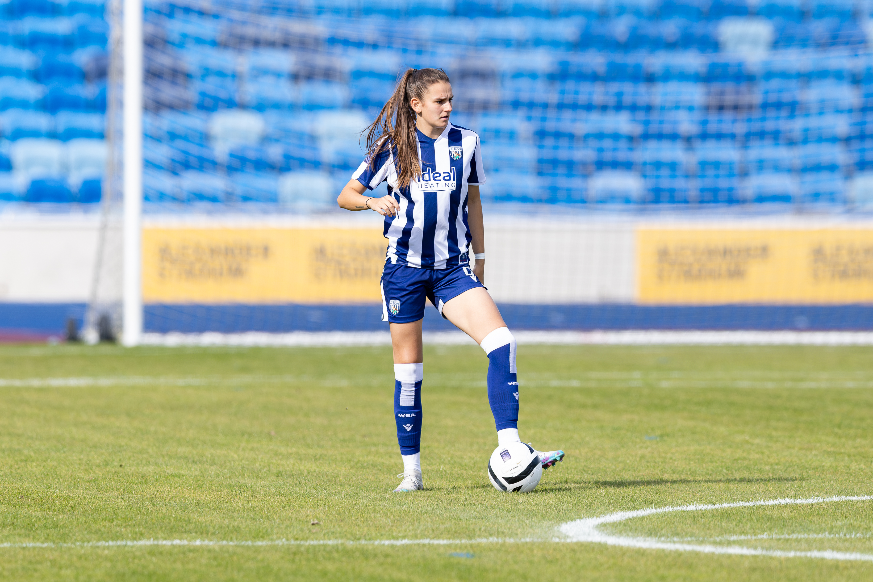 Izzy Green on the ball while during a game for WBA Women in the home kit 
