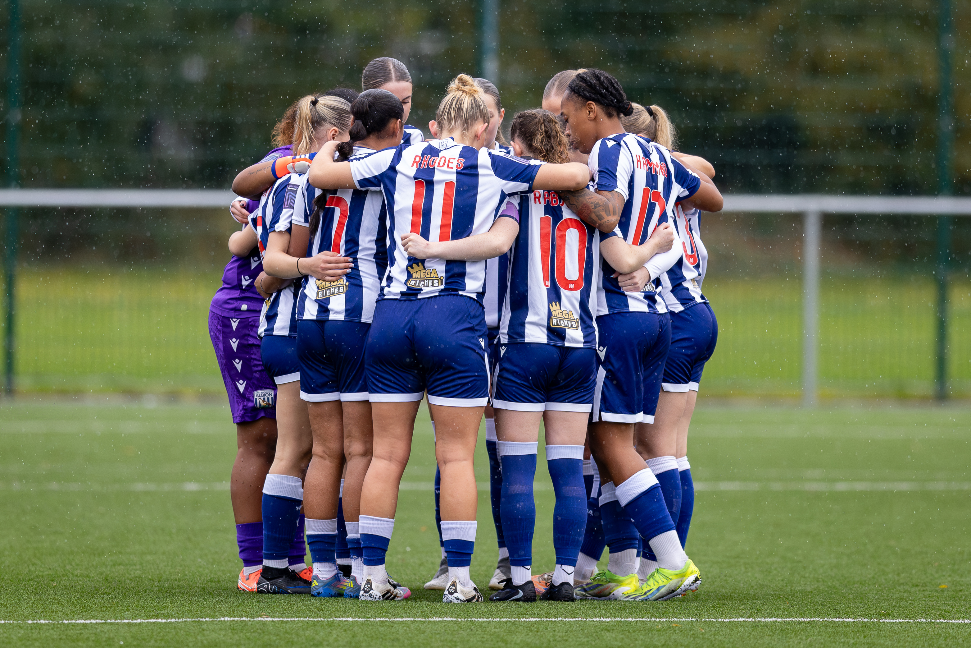 Albion Women in a team huddle.