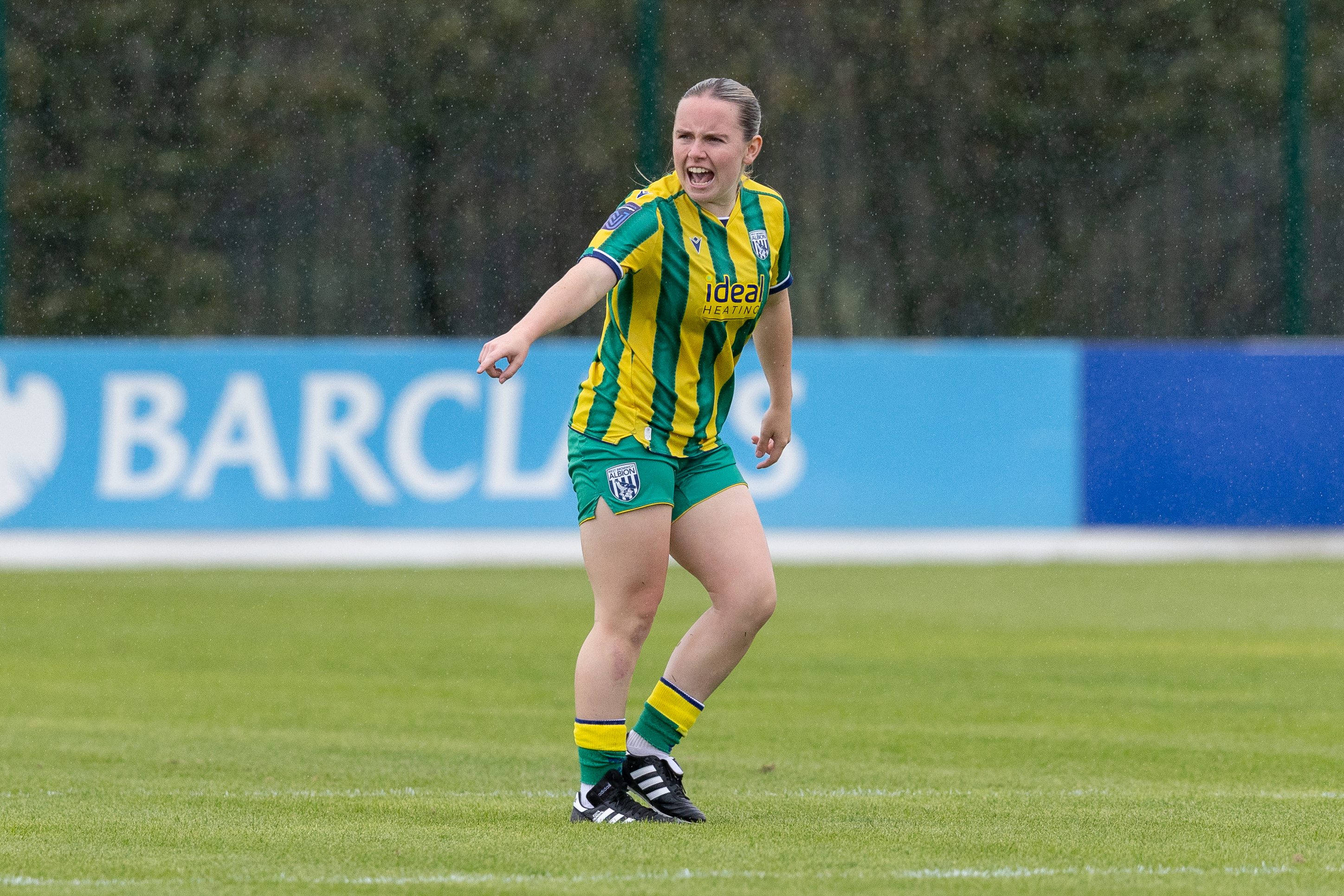 Ella Haughey in action for WBA Women in the green and yellow away 