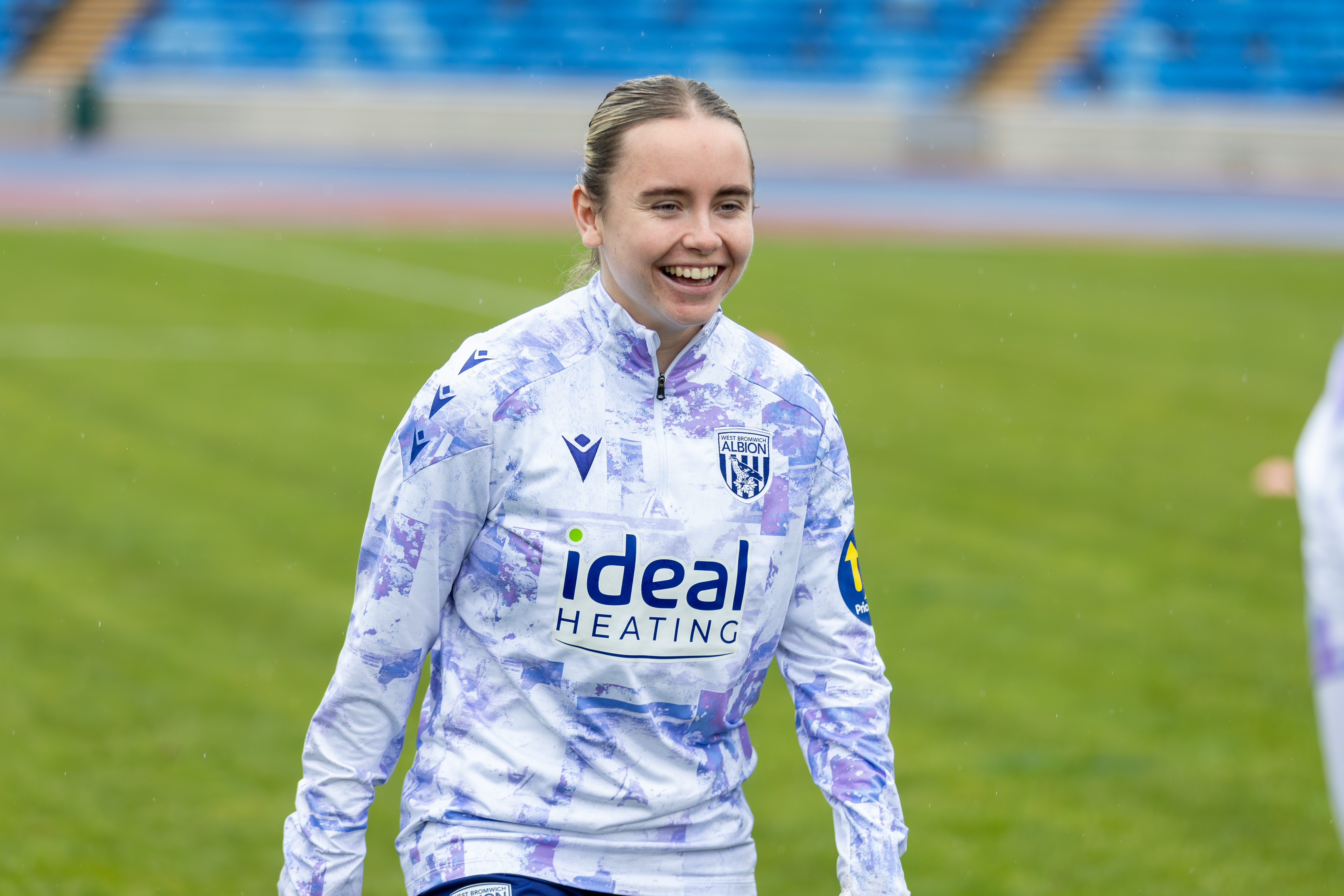 Ella Haughey smiling while warming up for a game