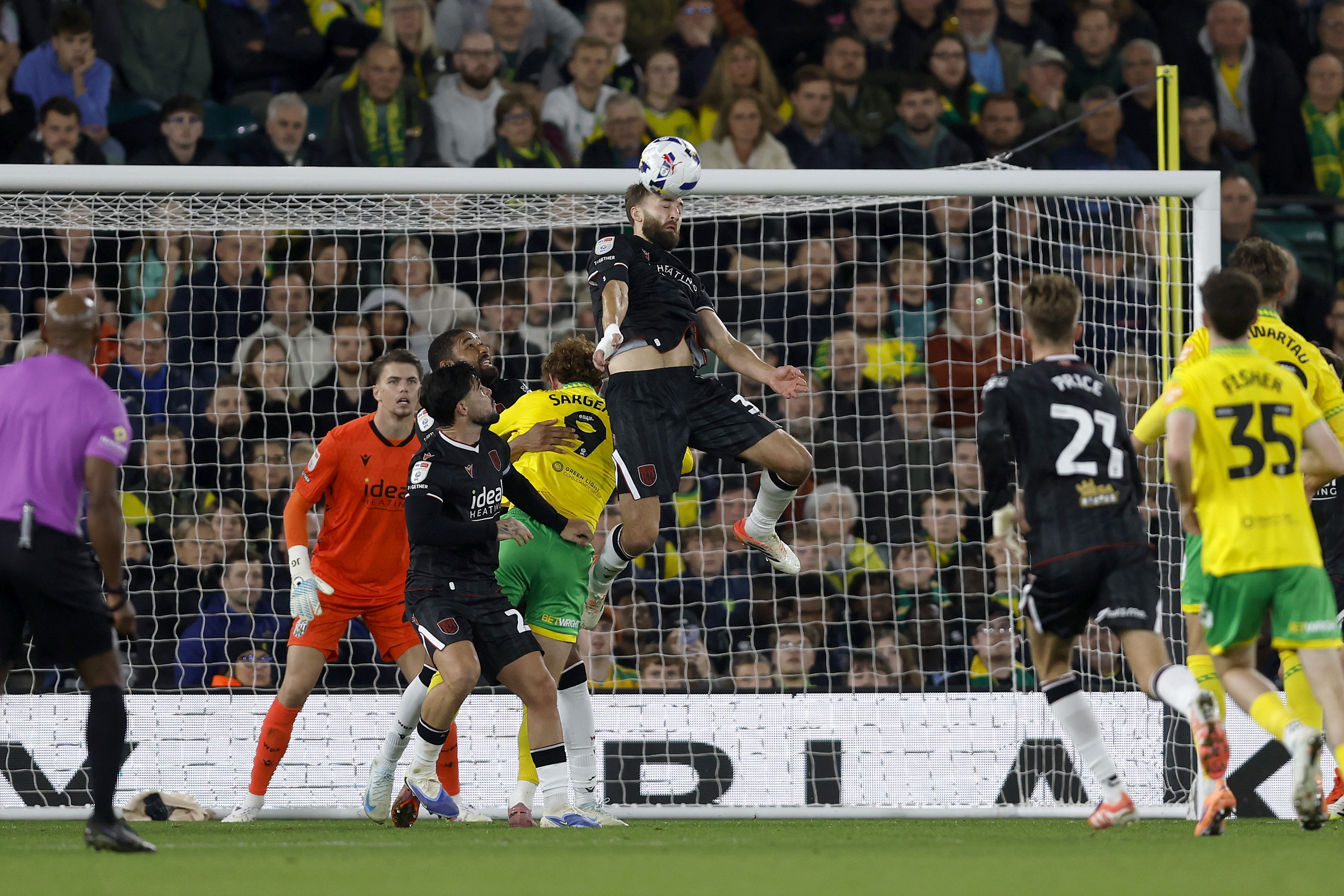 Nat Phillips jumping to head the ball against Norwich City