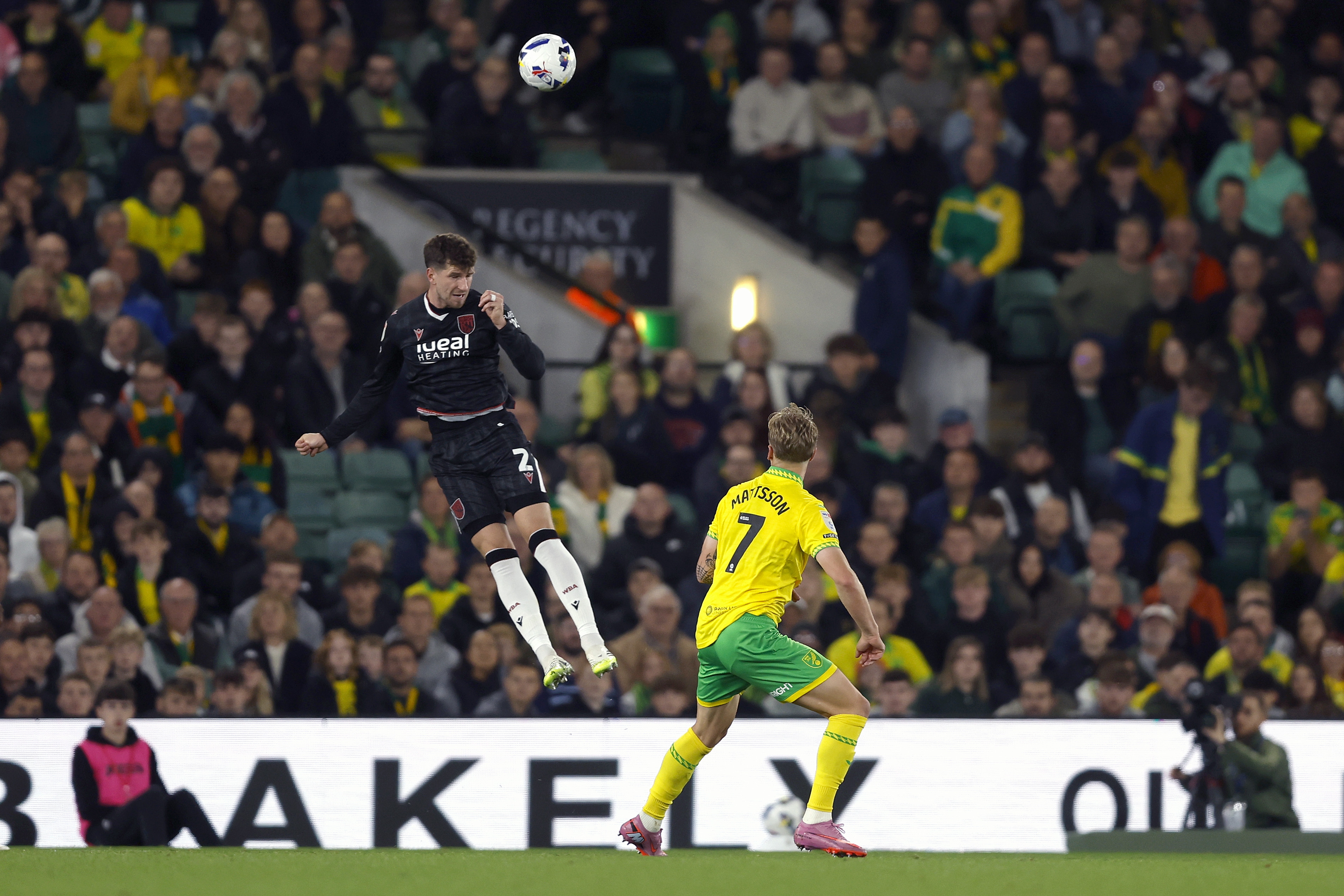 Chris Mepham jumping to head the ball against Norwich 