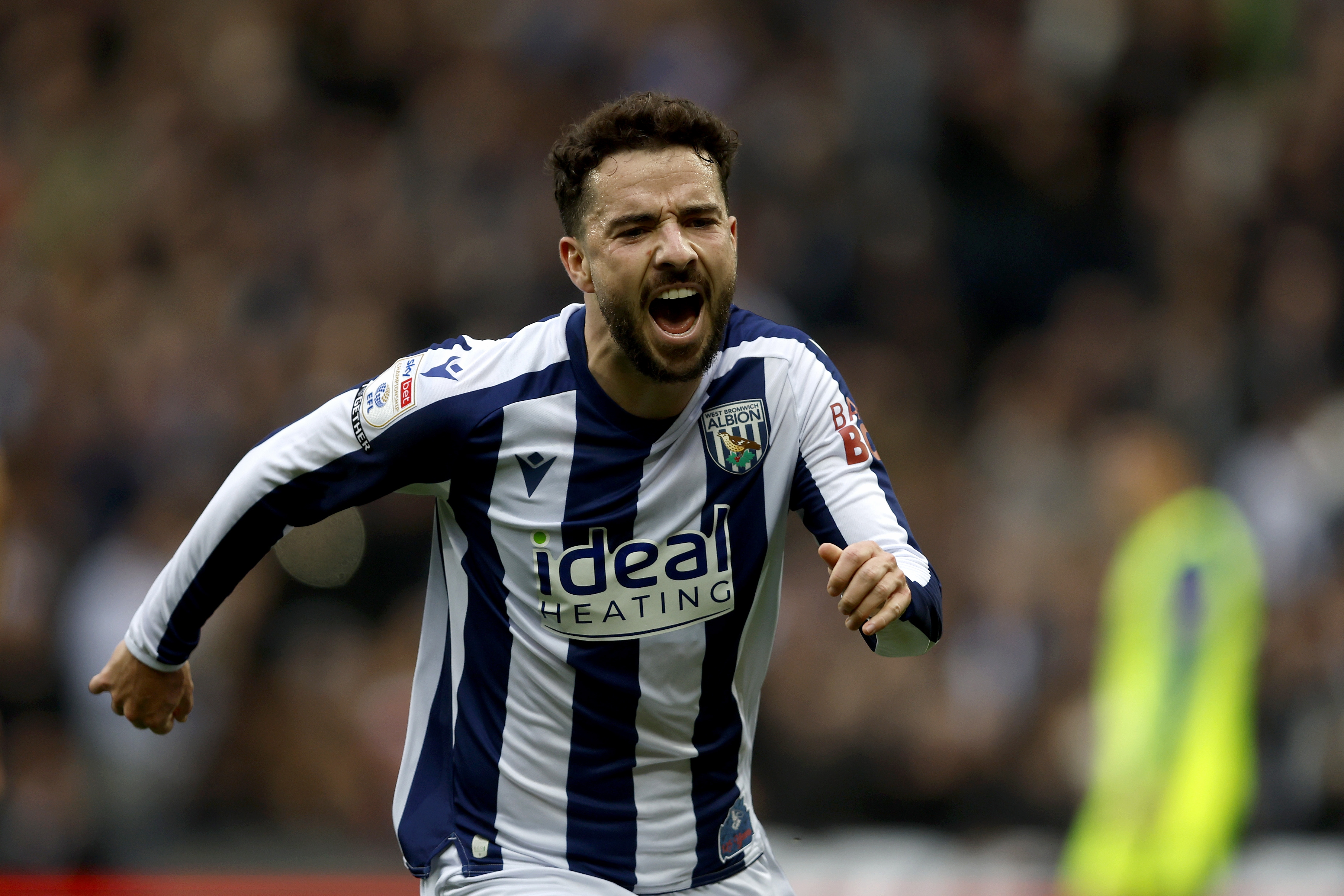 Mikey Johnston celebrates scoring against Preston in the home kit