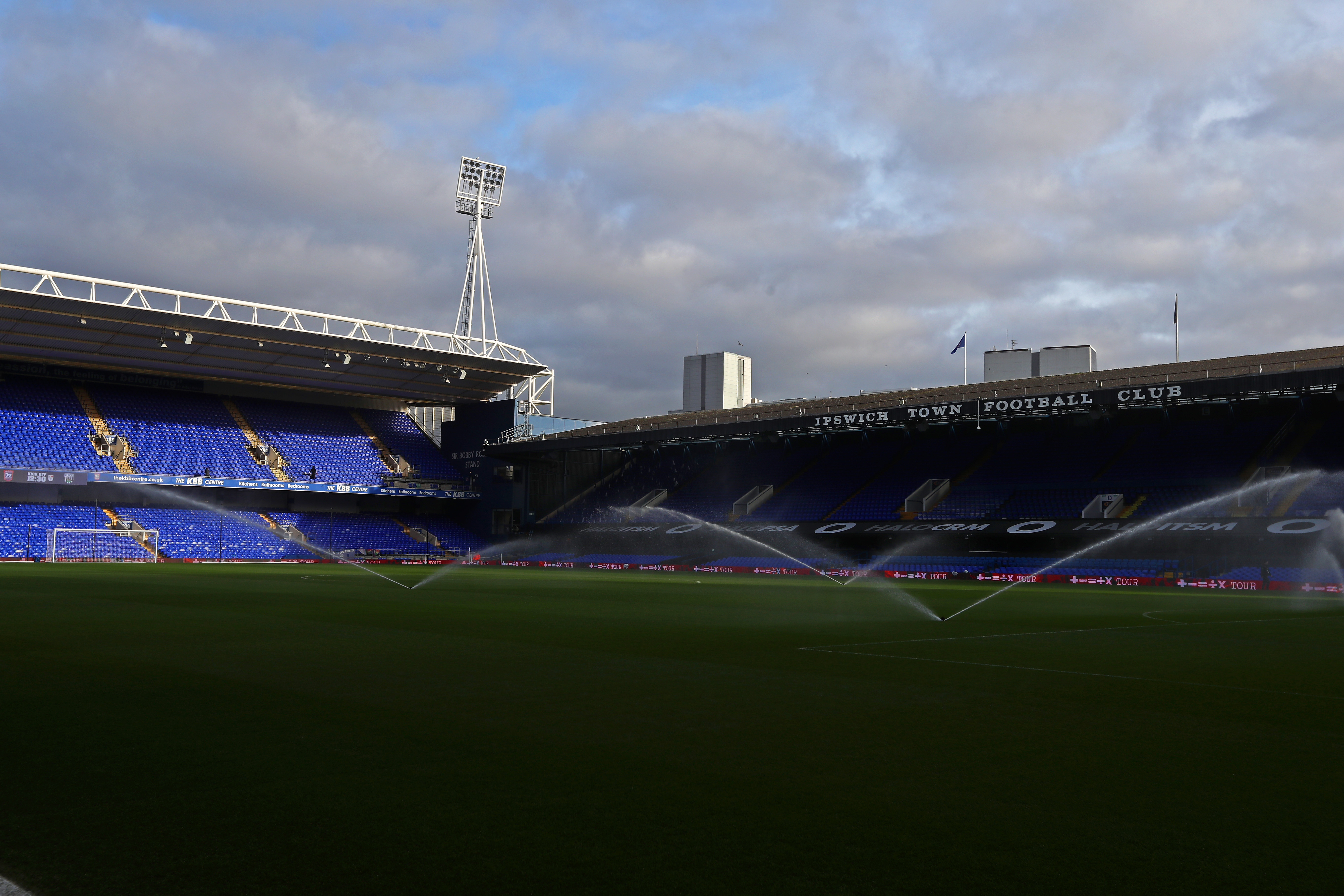 A general view of Portman Road in the sun with sprinklers on the pitch