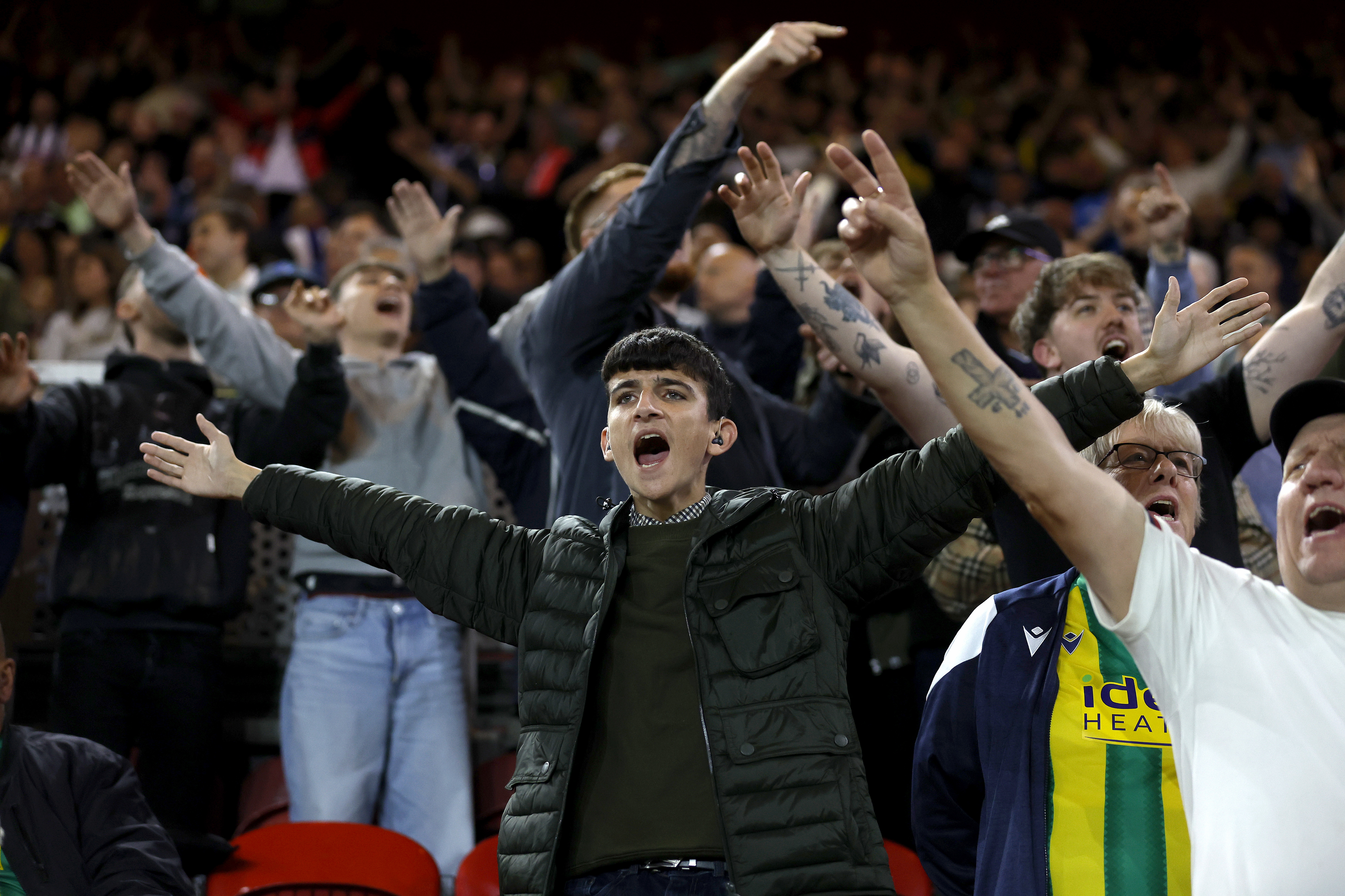 A general view of a young WBA fan cheering at a game