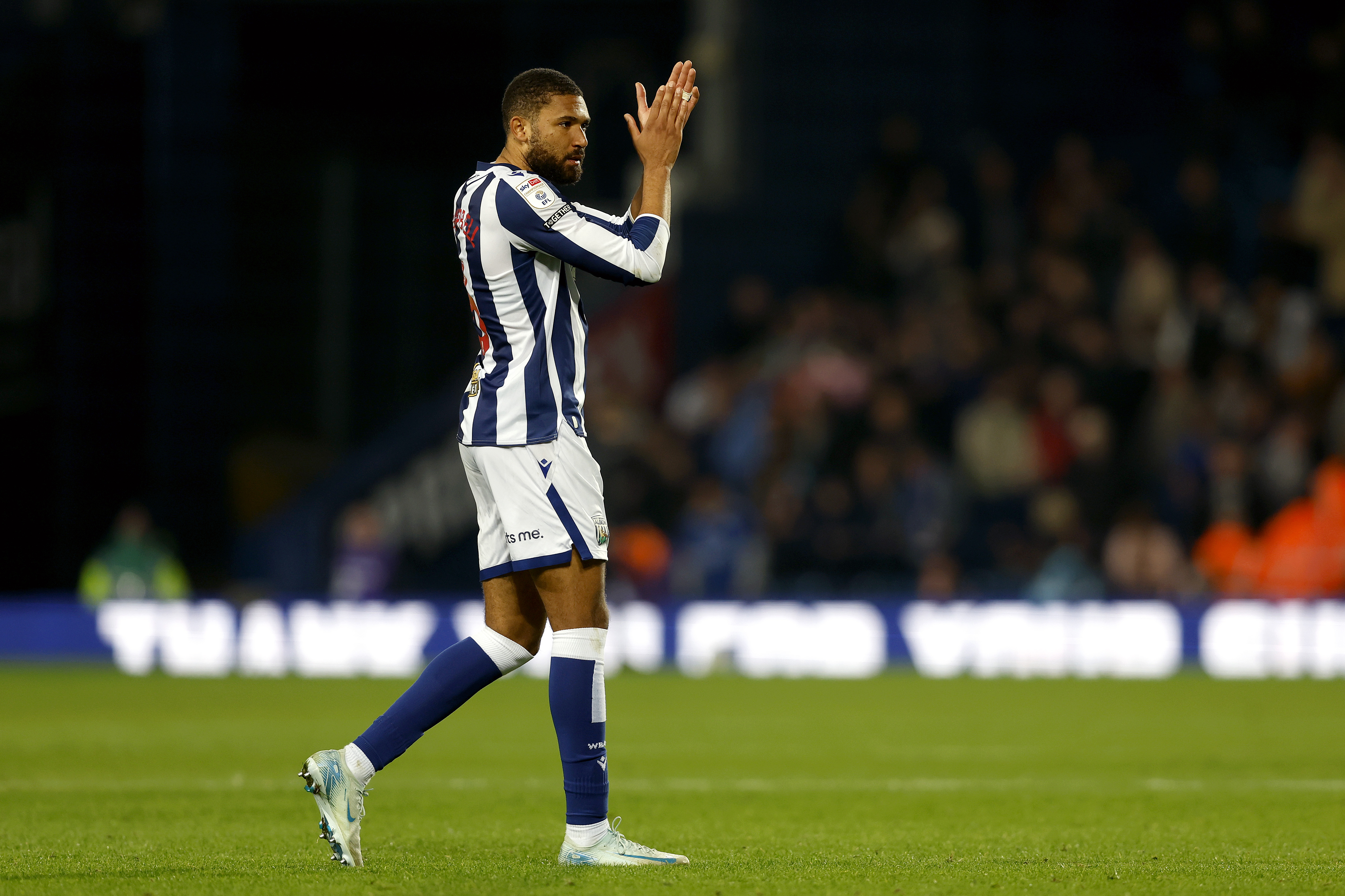 George Campbell clapping his hands while wearing the home kit