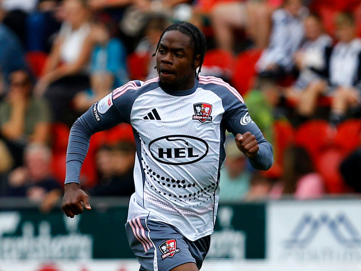 A photo of Akeel Higgins in action for loan club Exeter City in their white away kit