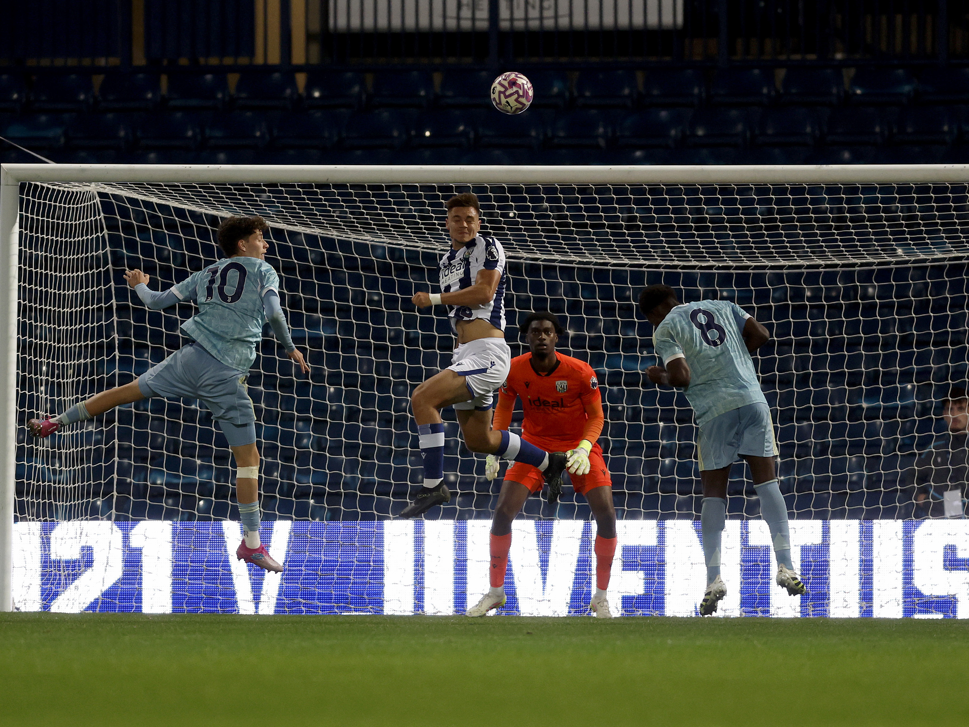 A photo of U21 defender Evan Humphries heading the ball