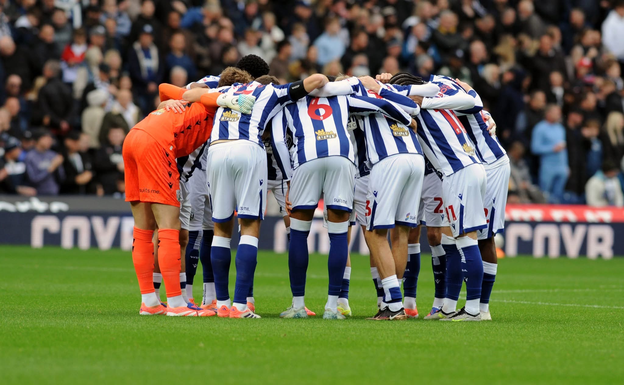 WBA in a team huddle in the home kit before a game