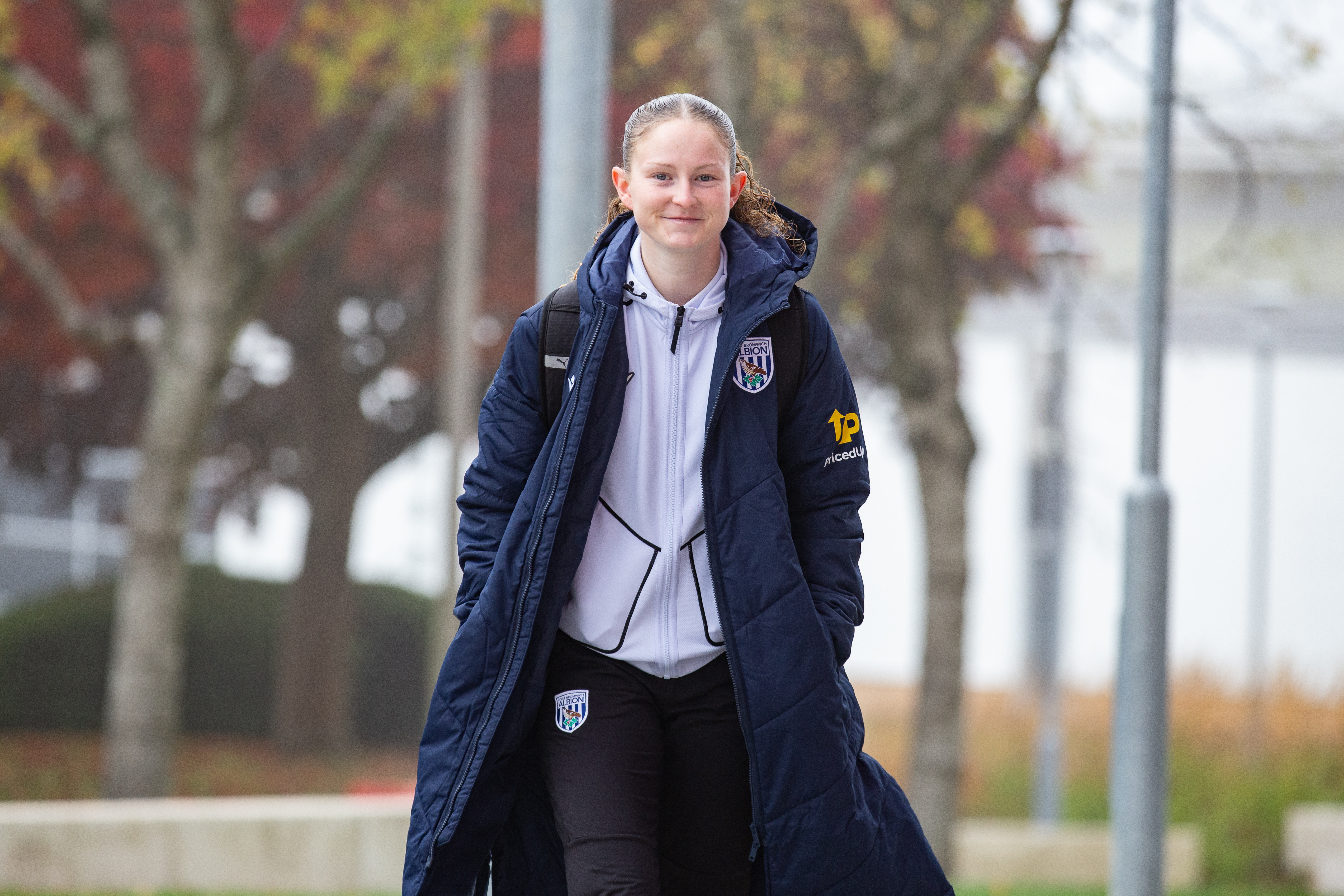 Liv Rabjohn smiling at the camera as she arrives for a game 