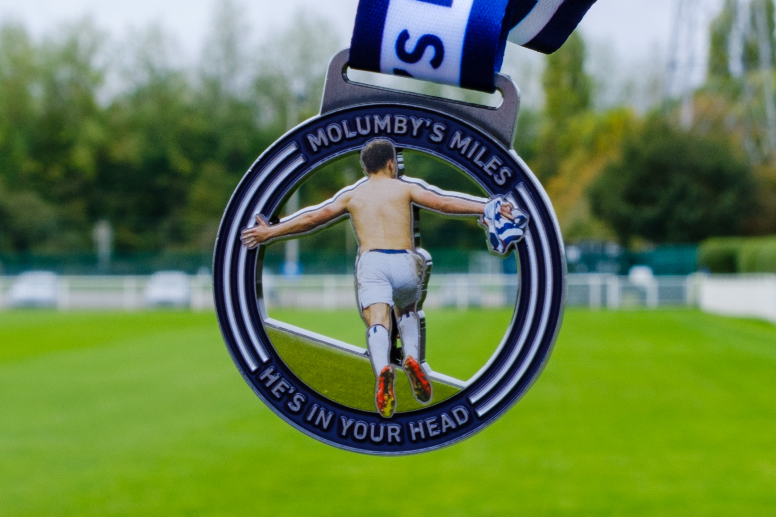 Molumby's Miles Medal with a pitch in the background.
