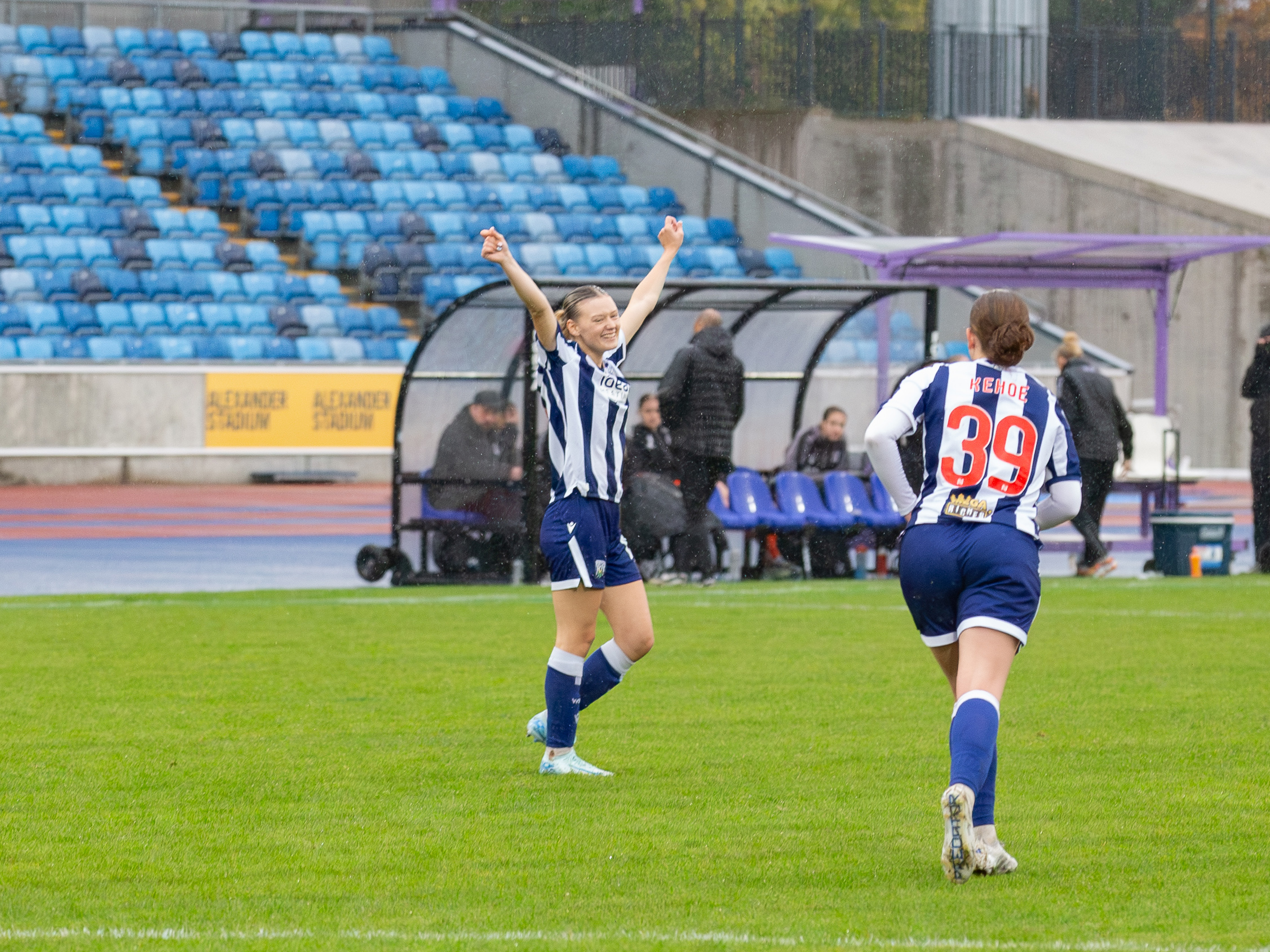 An image of Naomi Sharp celebrating a goal with her teammates