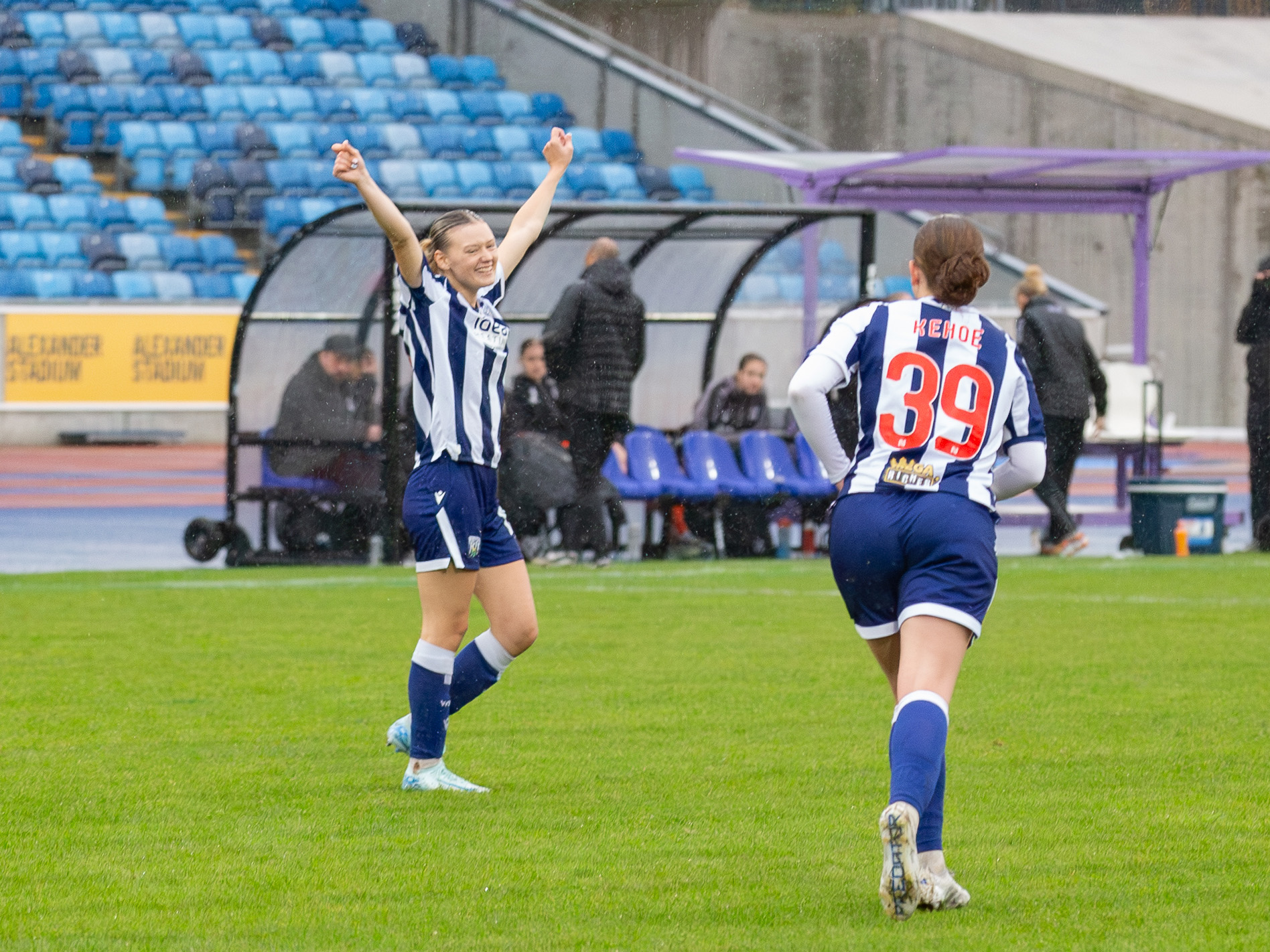Naomi Sharp celebrates scoring against Boldmere in the home kit