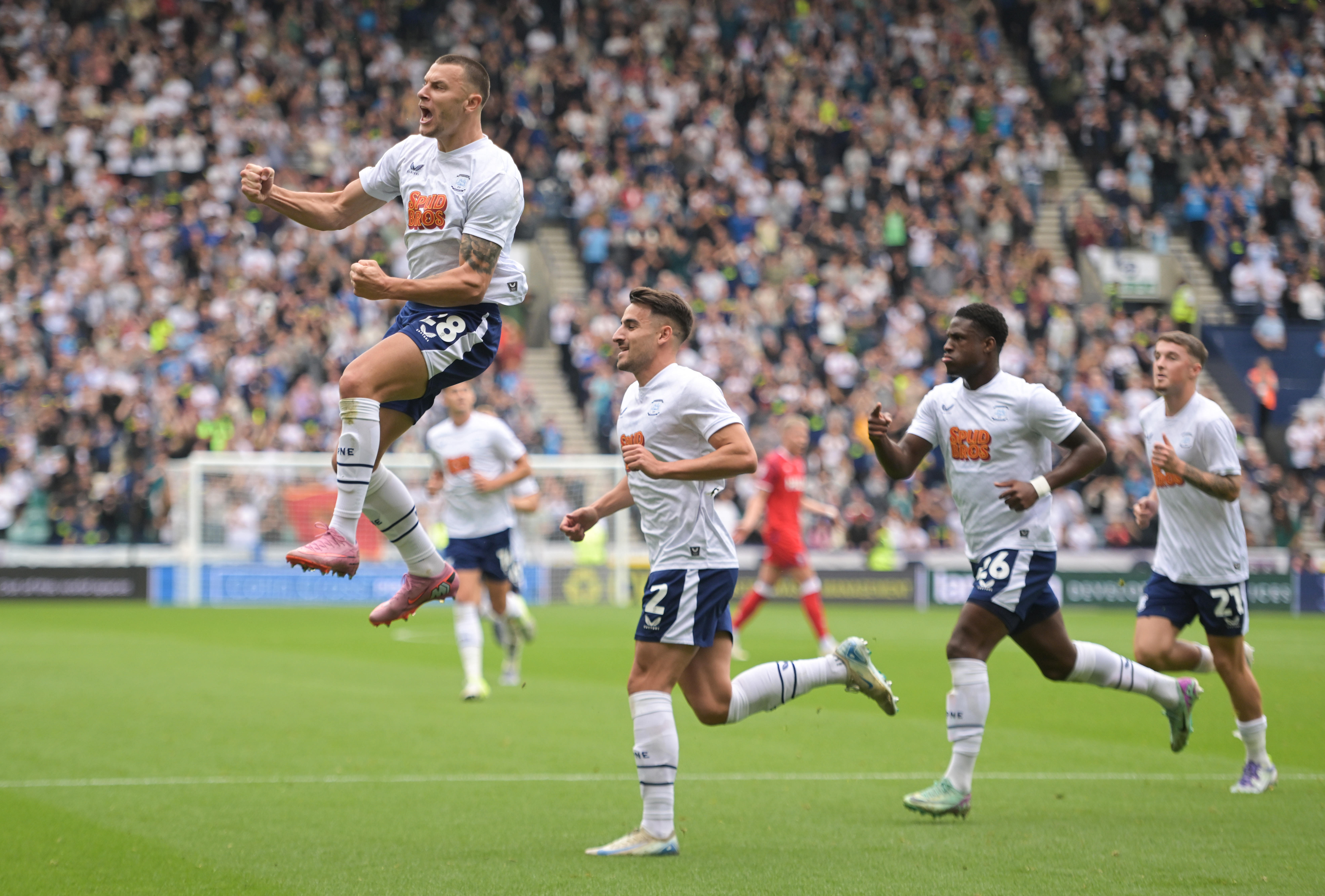 Several Preston players celebrating a goal scored in their home kit