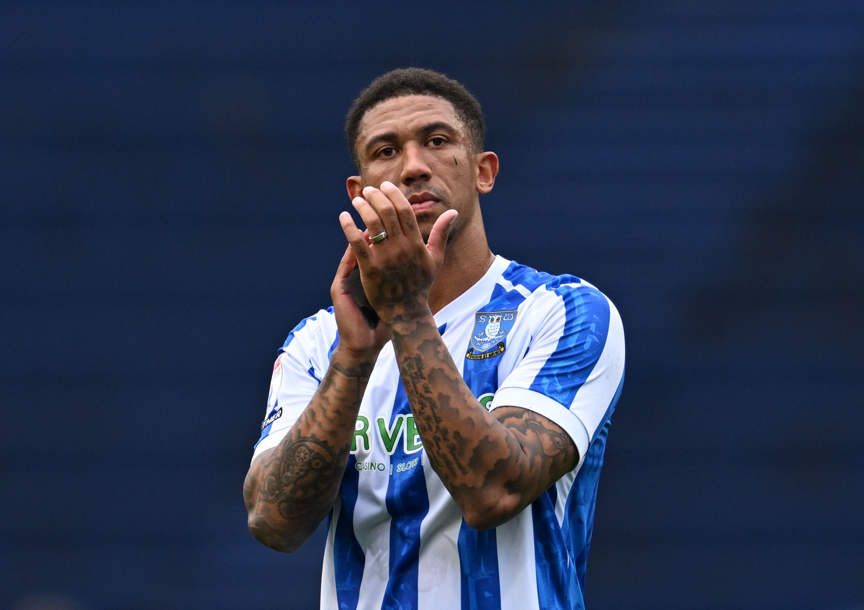 Liam Palmer of Sheffield Wednesday clapping his hands wearing their home kit