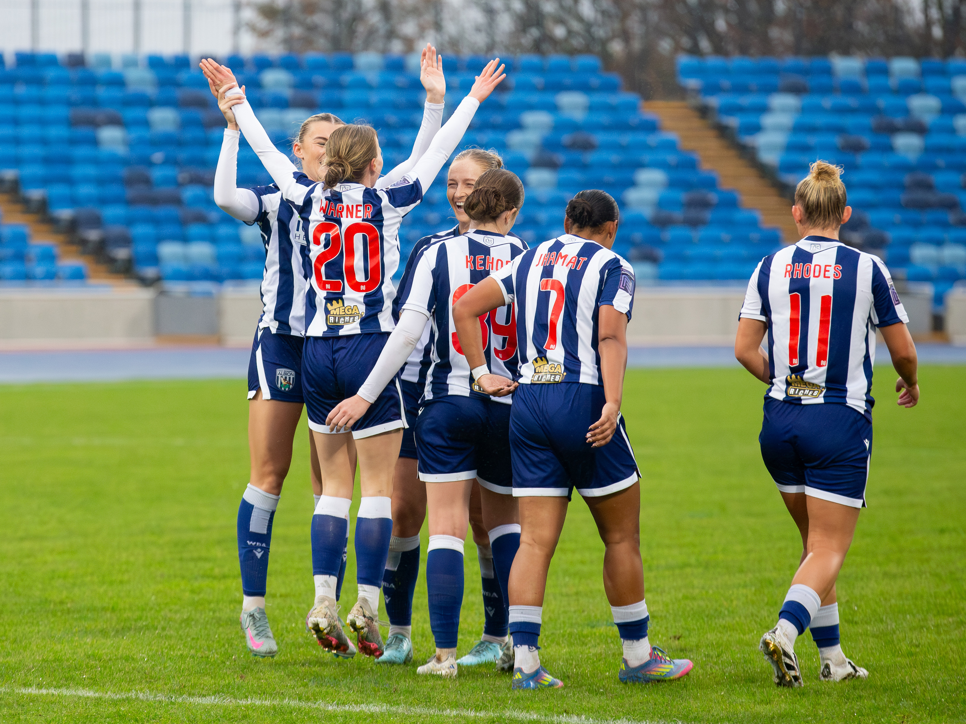 An image of Phoebe Warner celebrating a goal with her teammates