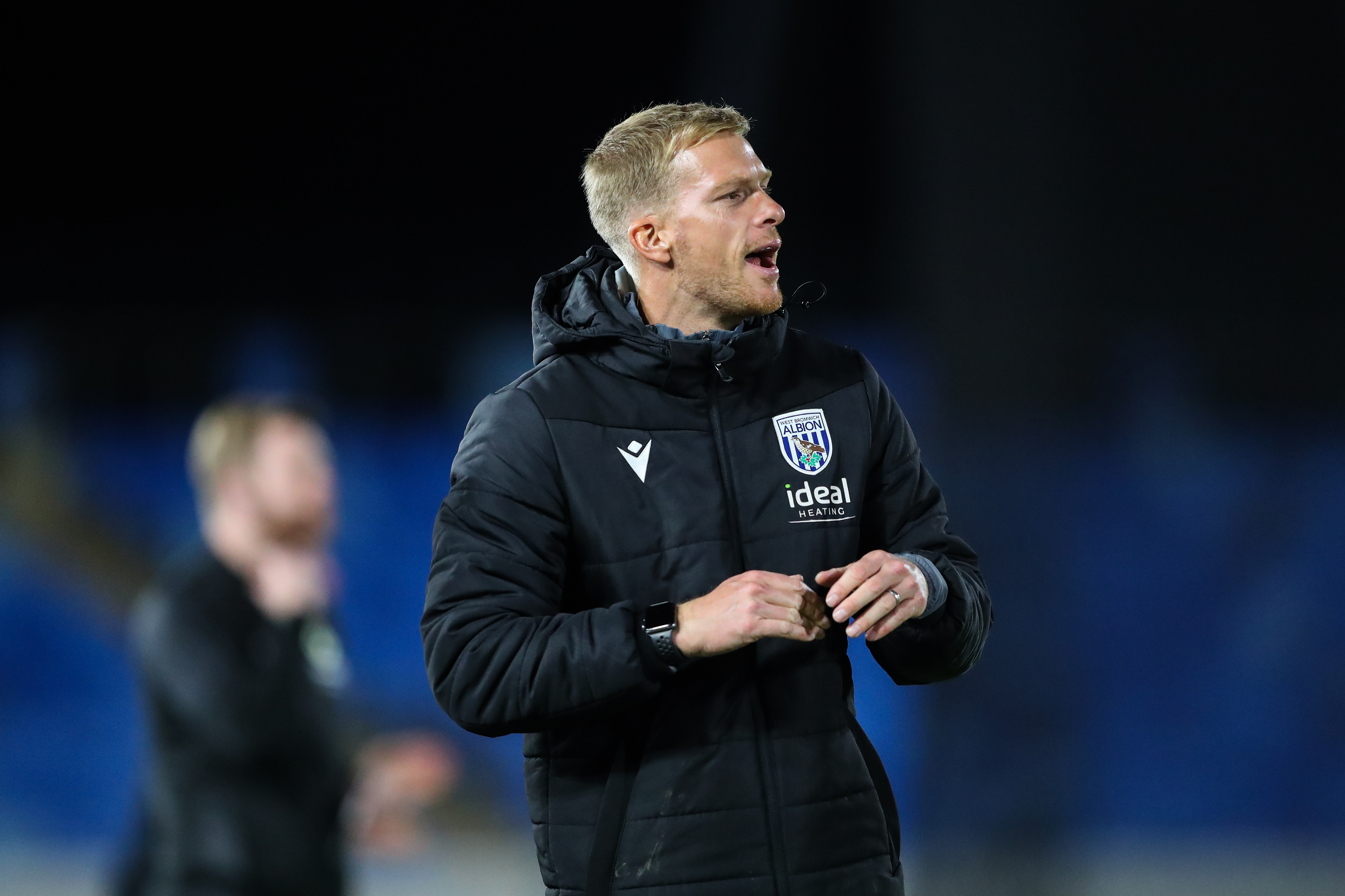 Leigh Downing on the side of the pitch shouting instructions to players