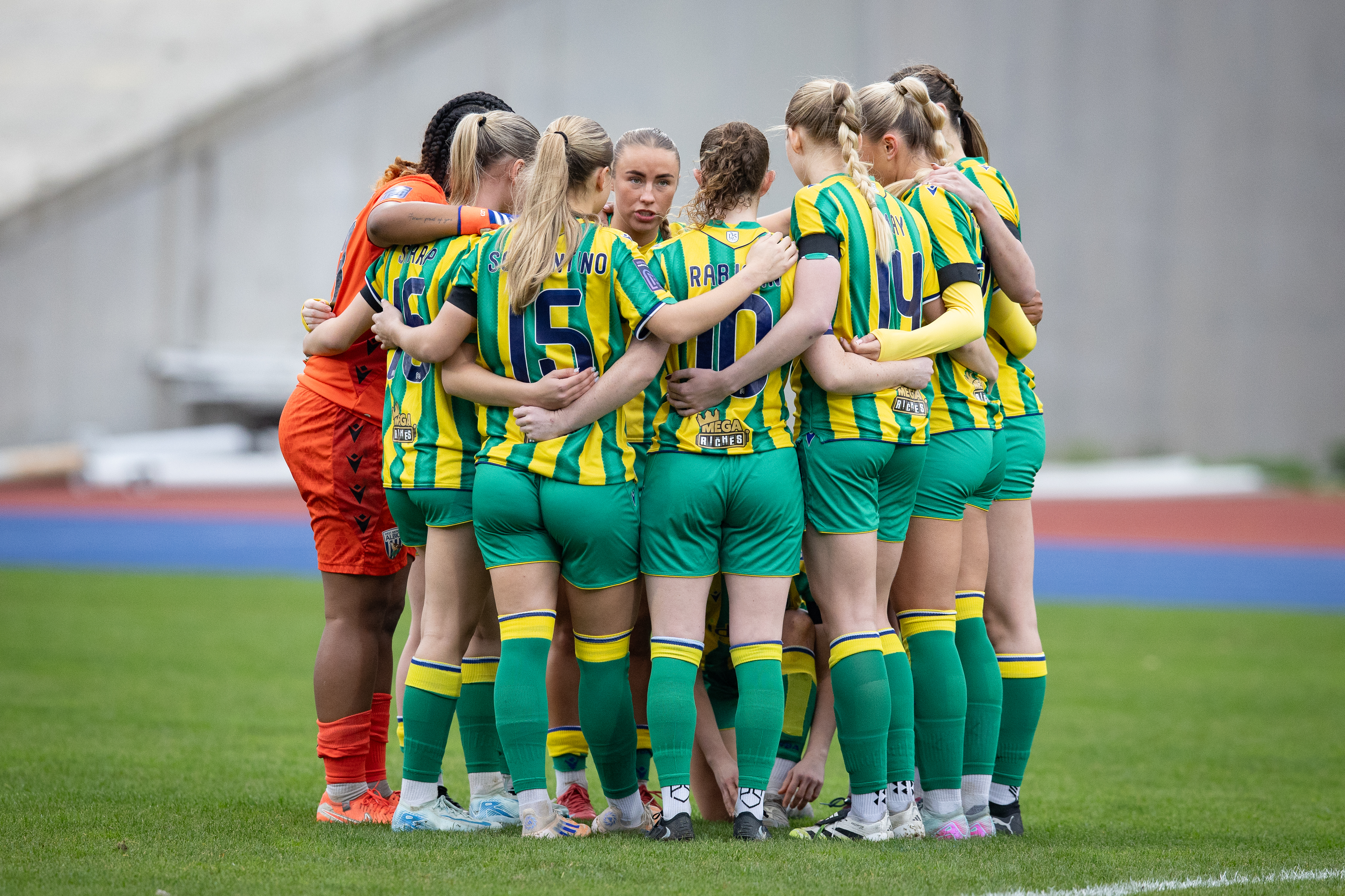Albion Women in a team huddle.
