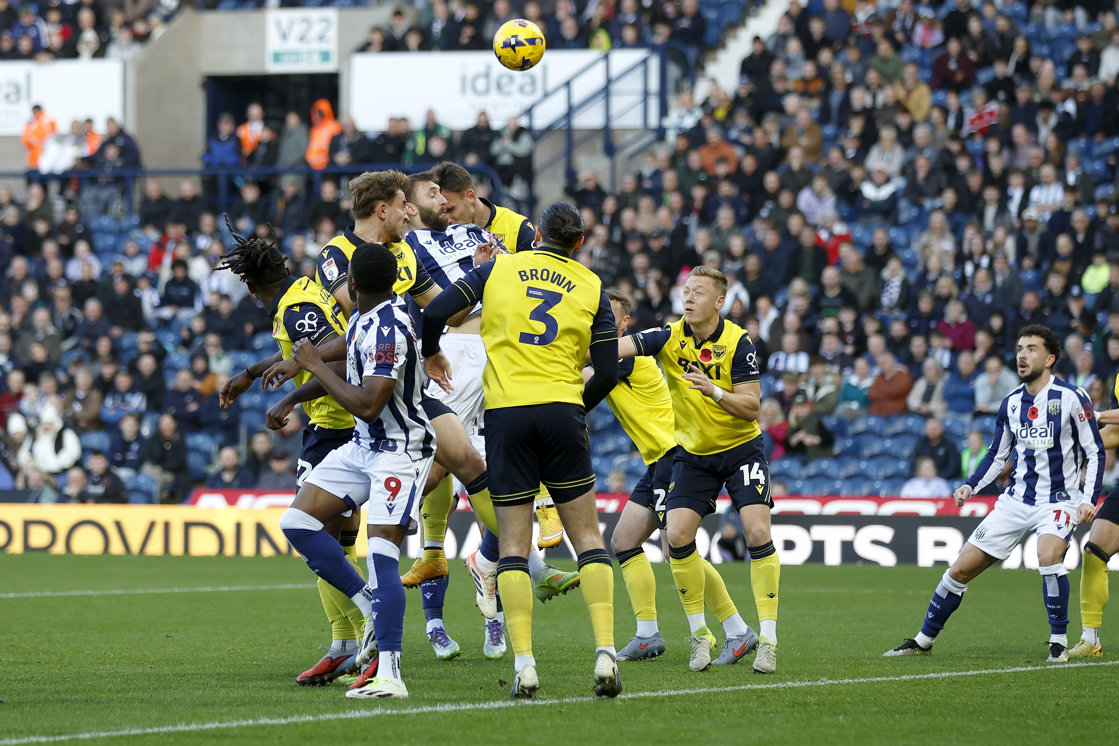 Several WBA & Oxford players jumping for the ball 