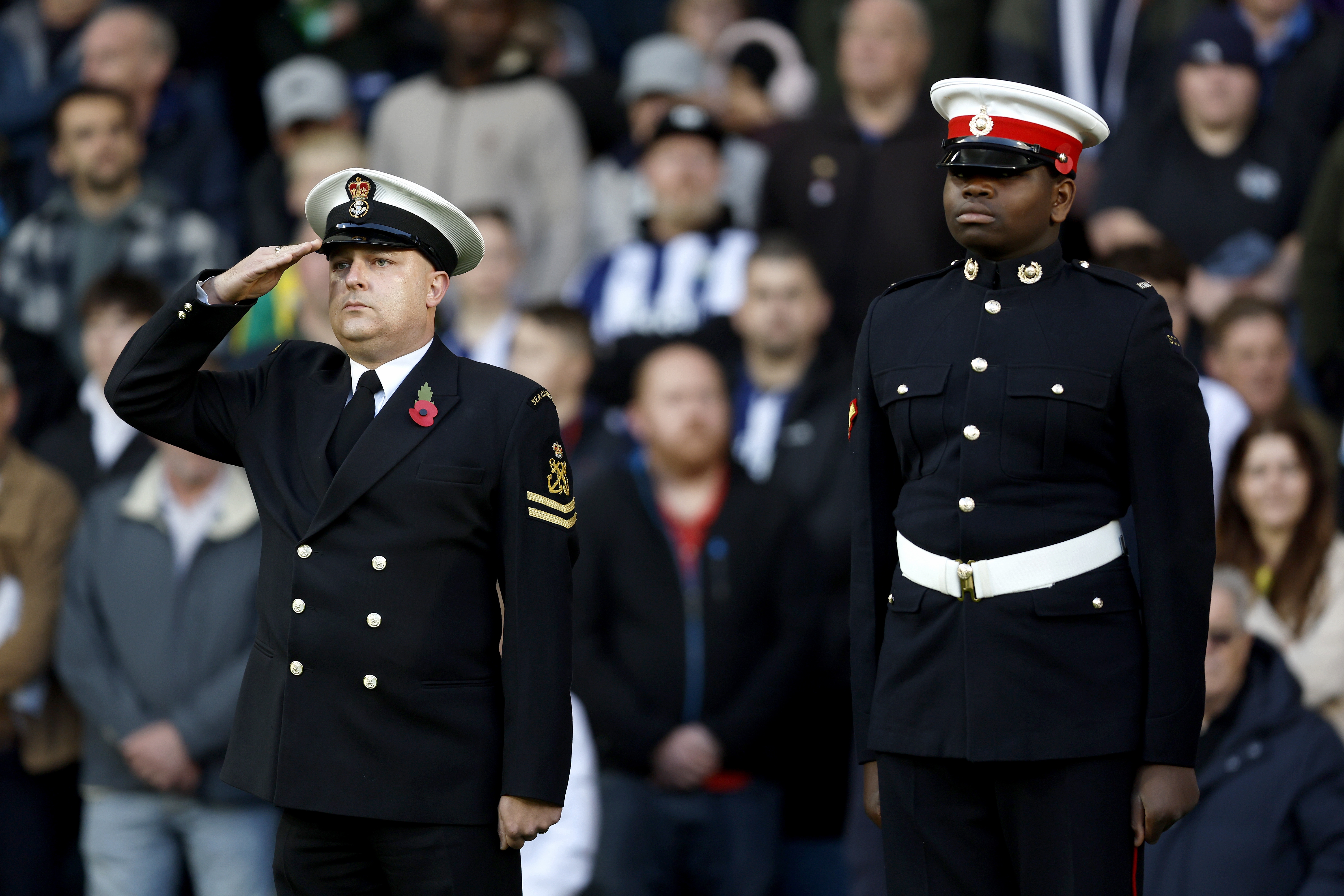 Servicemen standing to attention before the WBA vs Oxford game