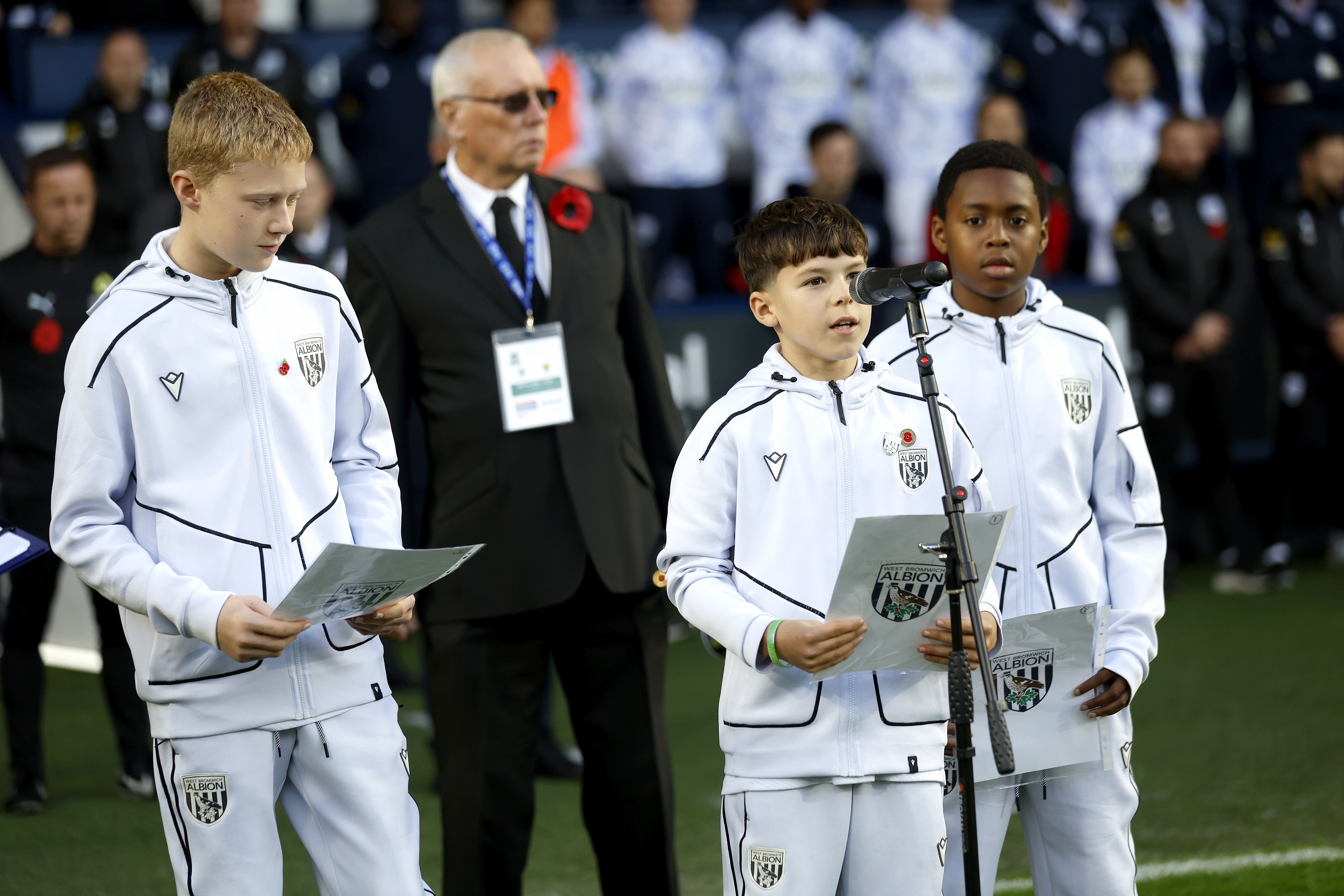 U12 academy players delivering a reading on the side of the pitch at The Hawthorns 