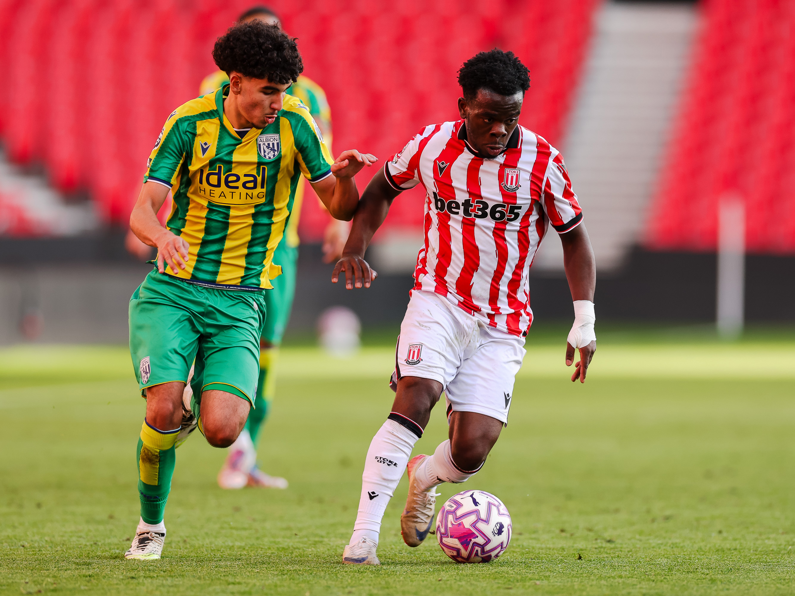 A photo of Albion U21 defender Adam Letlat in the 2025/26 green and yellow away kit