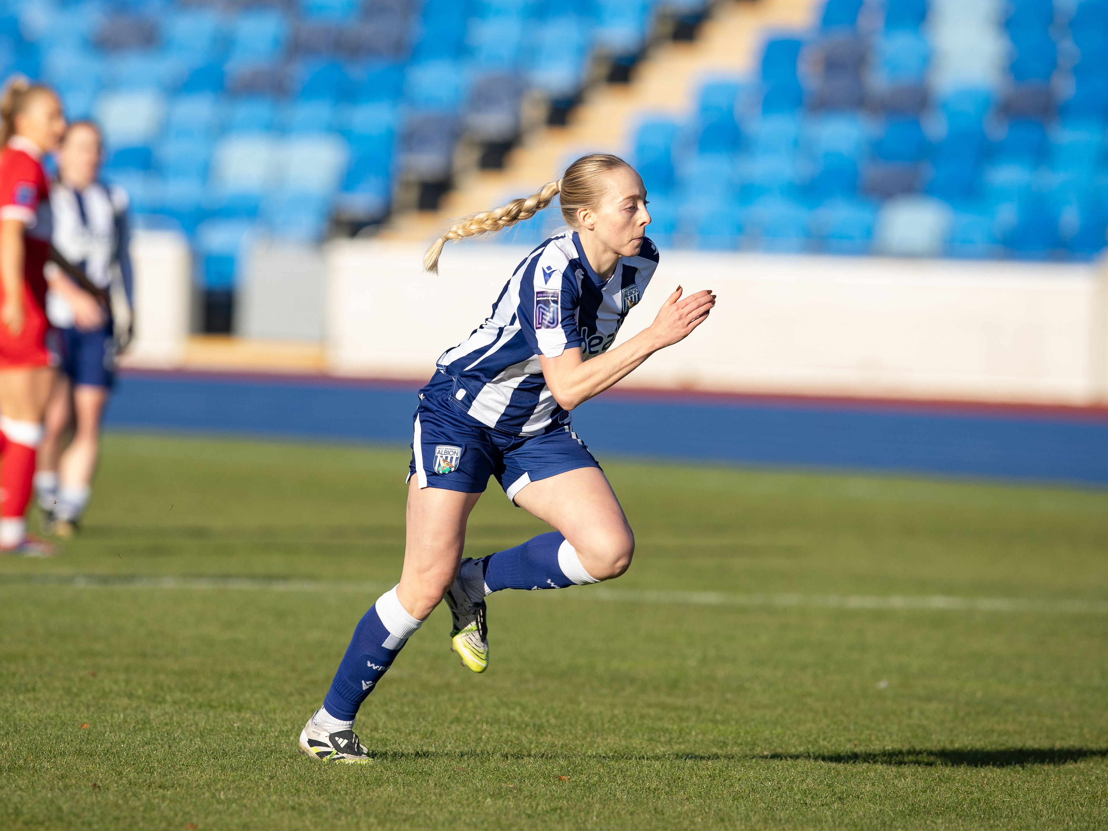 A photo of Ellie May playing football at the Alexander Stadium 
