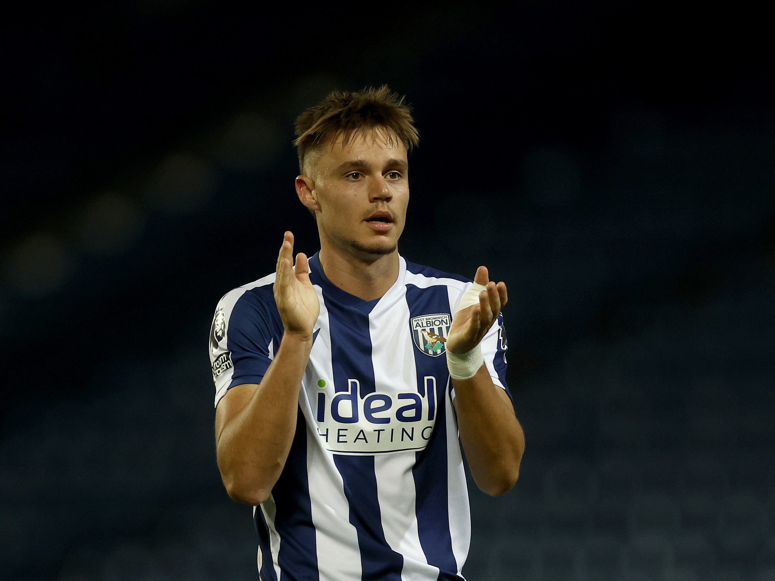 Evan Humphries clapping his hands in the home kit 