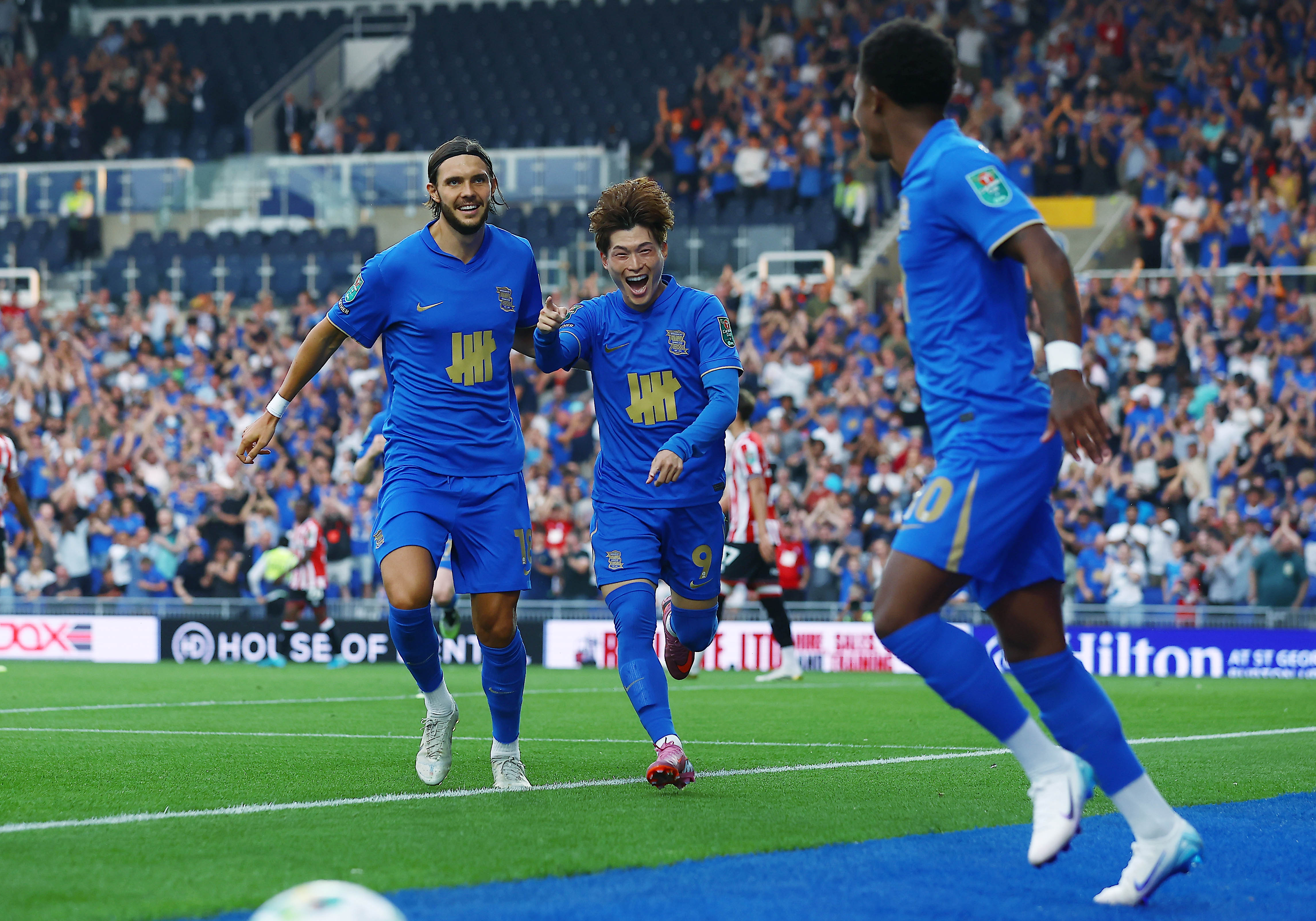 Kyogo Furuhashi celebrates scoring for Birmingham with two team-mates