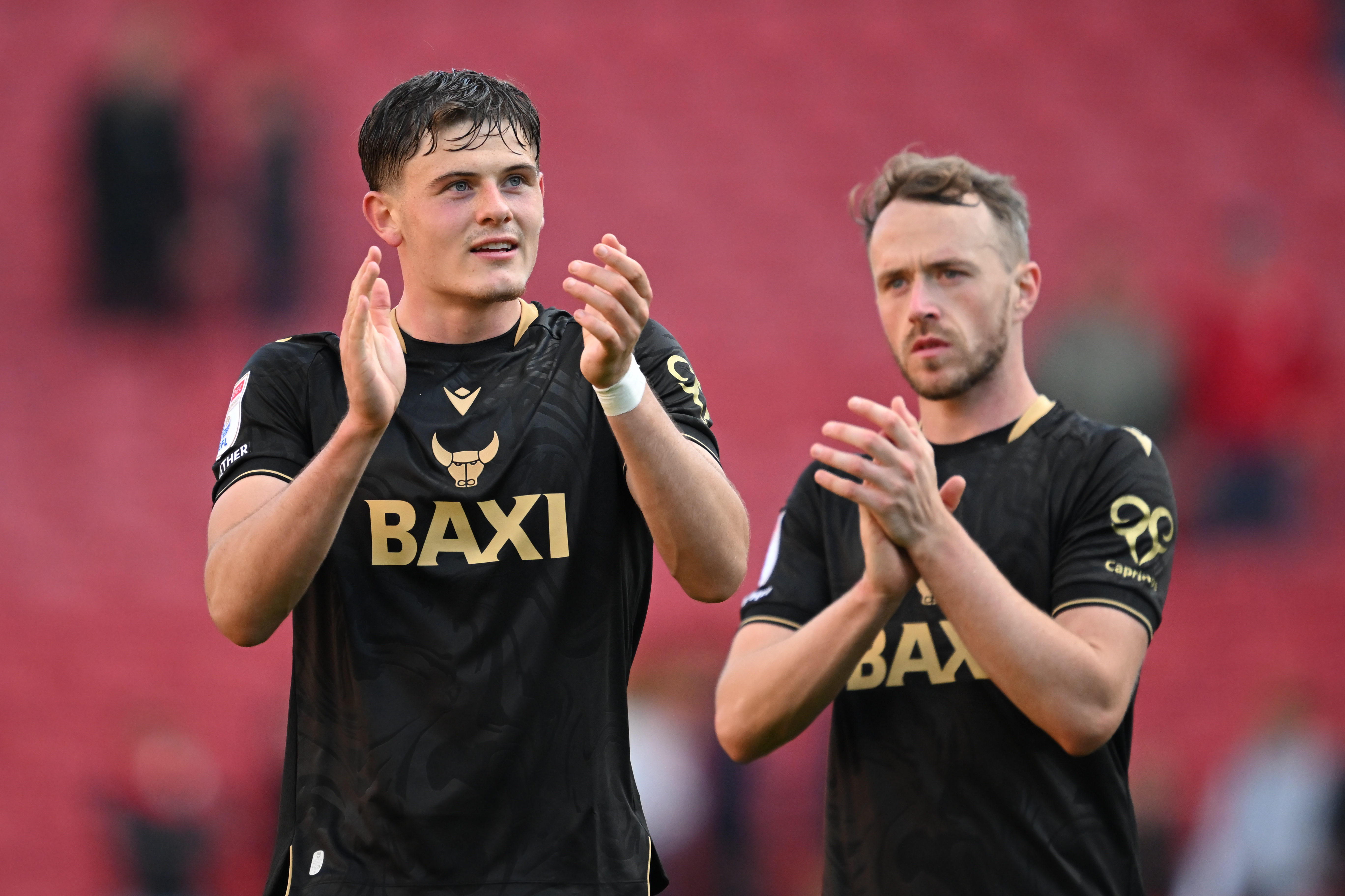 Will Lankshear clapping while wearing an Oxford shirt 