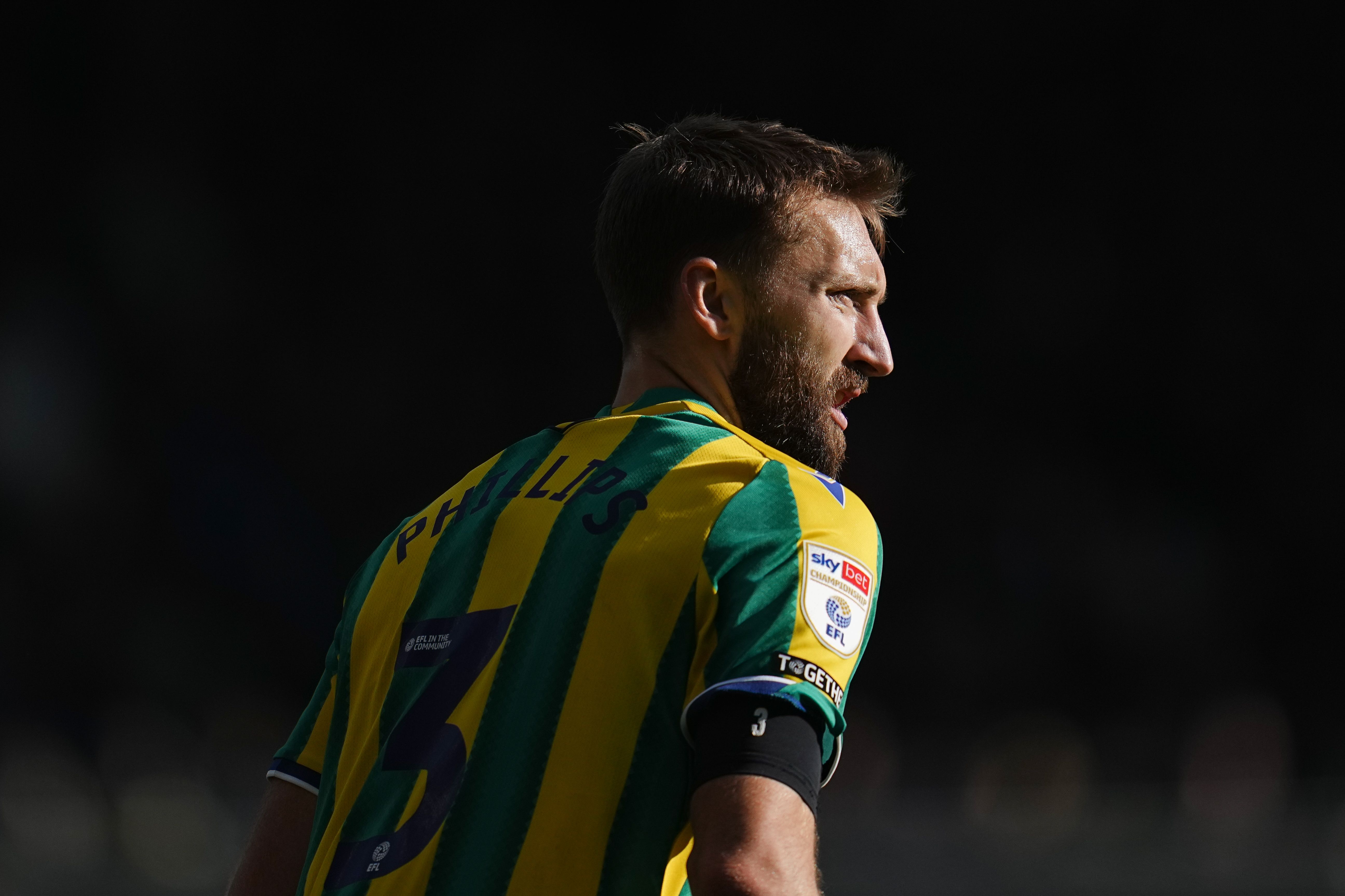 Nat Phillips in the green and yellow away kit during a game