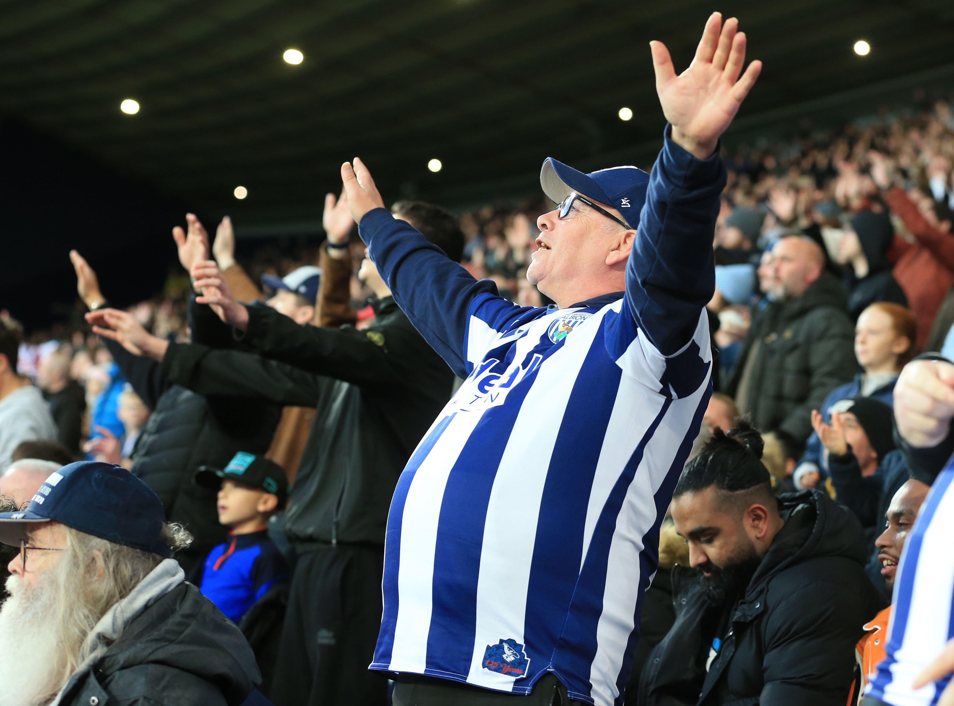 A general view of an Albion fan cheering at a game 