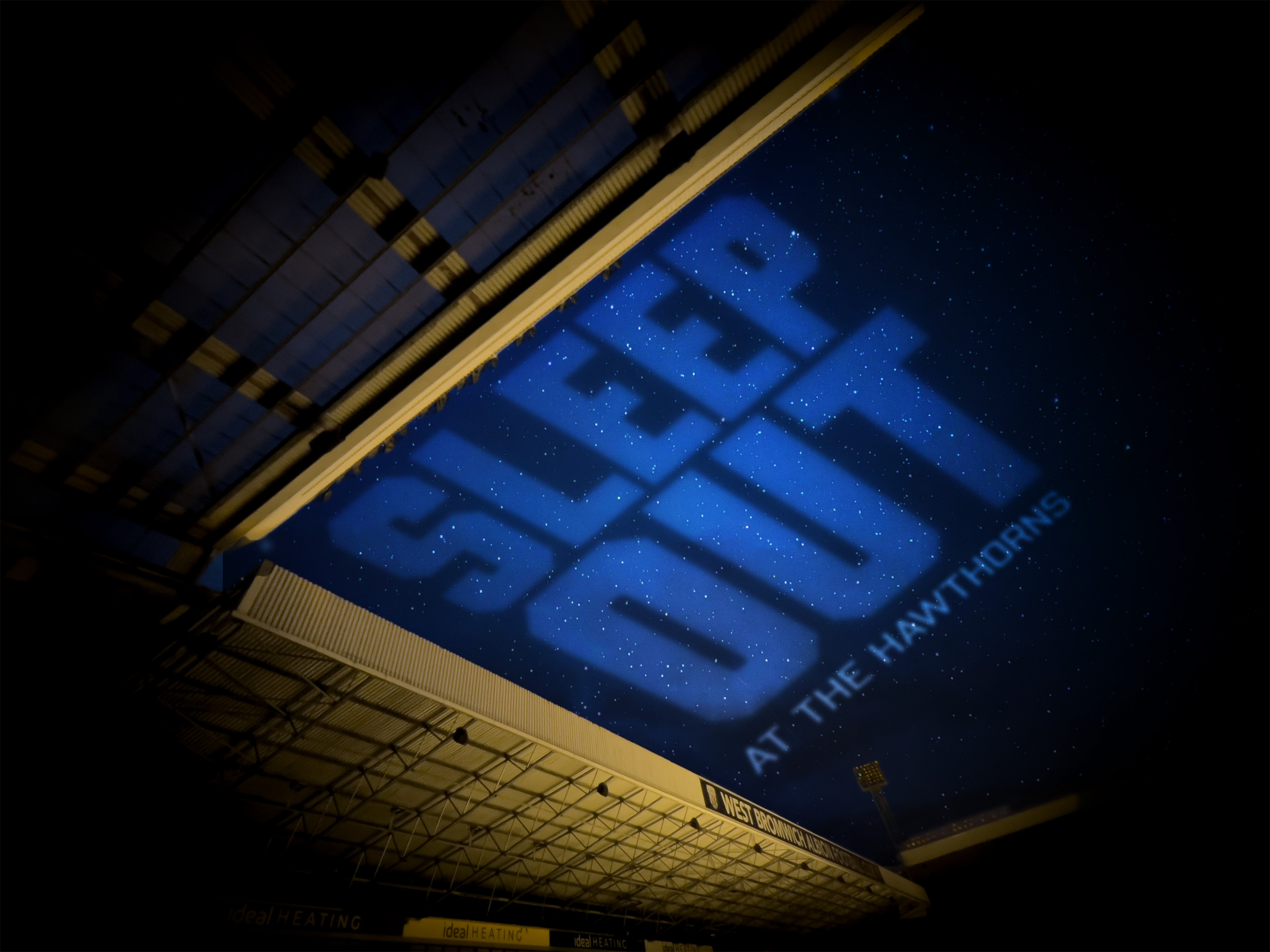 An upwards view from the stadium, with Sleep Ou text in the sky.