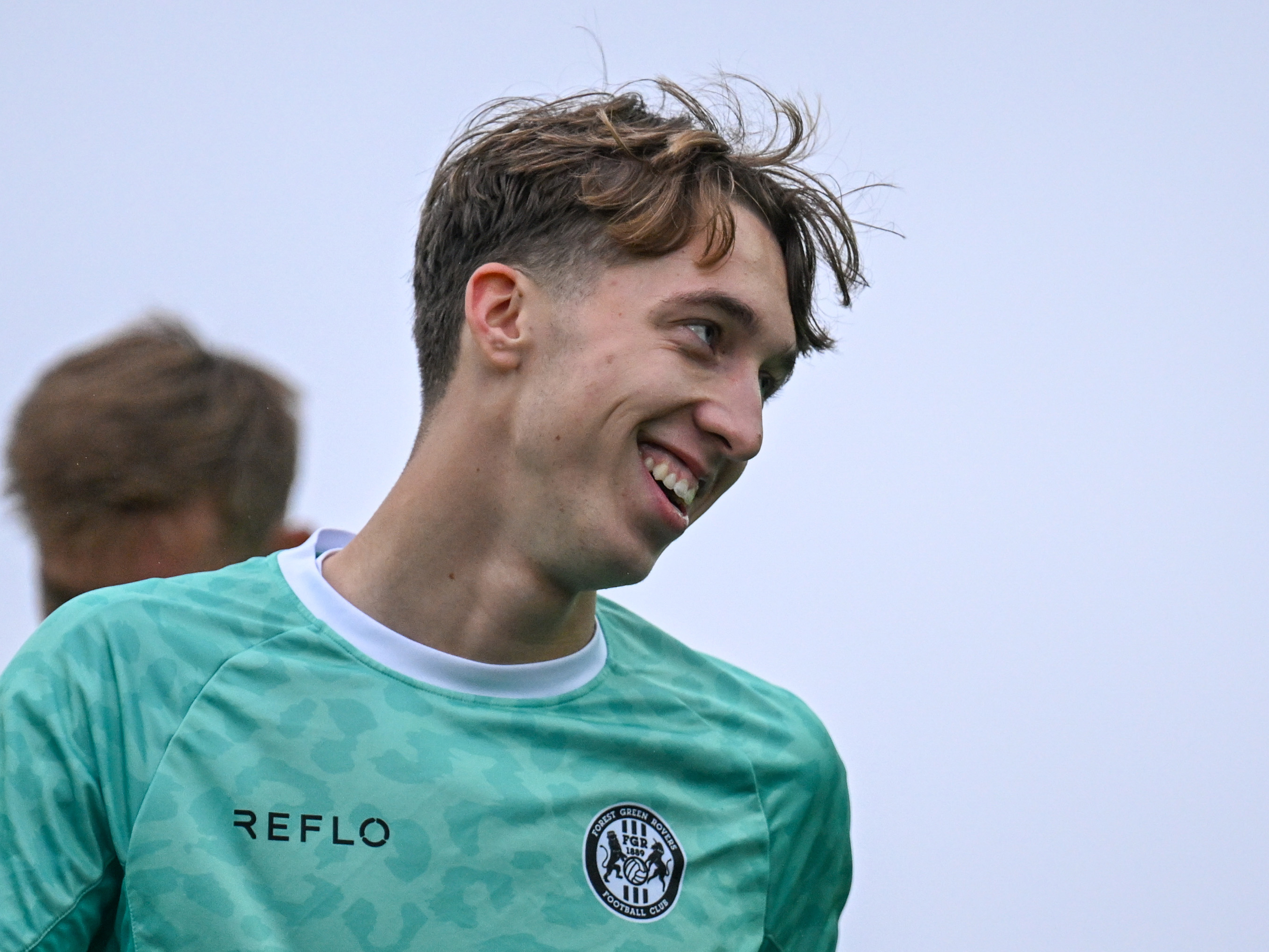 Harry Whitwell smiling while wearing Forest Green Rovers warm-up gear 