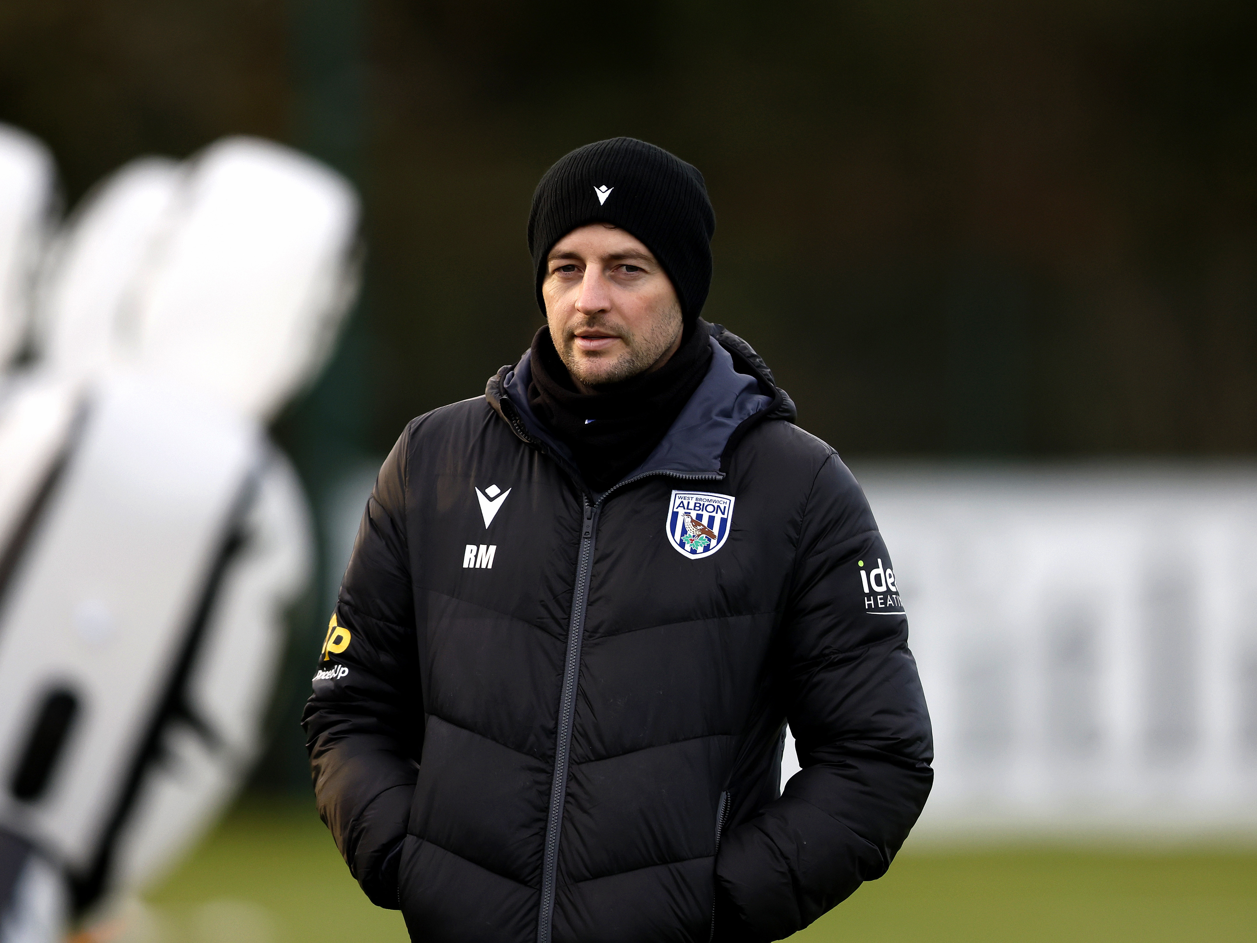 Ryan Mason wearing a coat and a hat during a training session