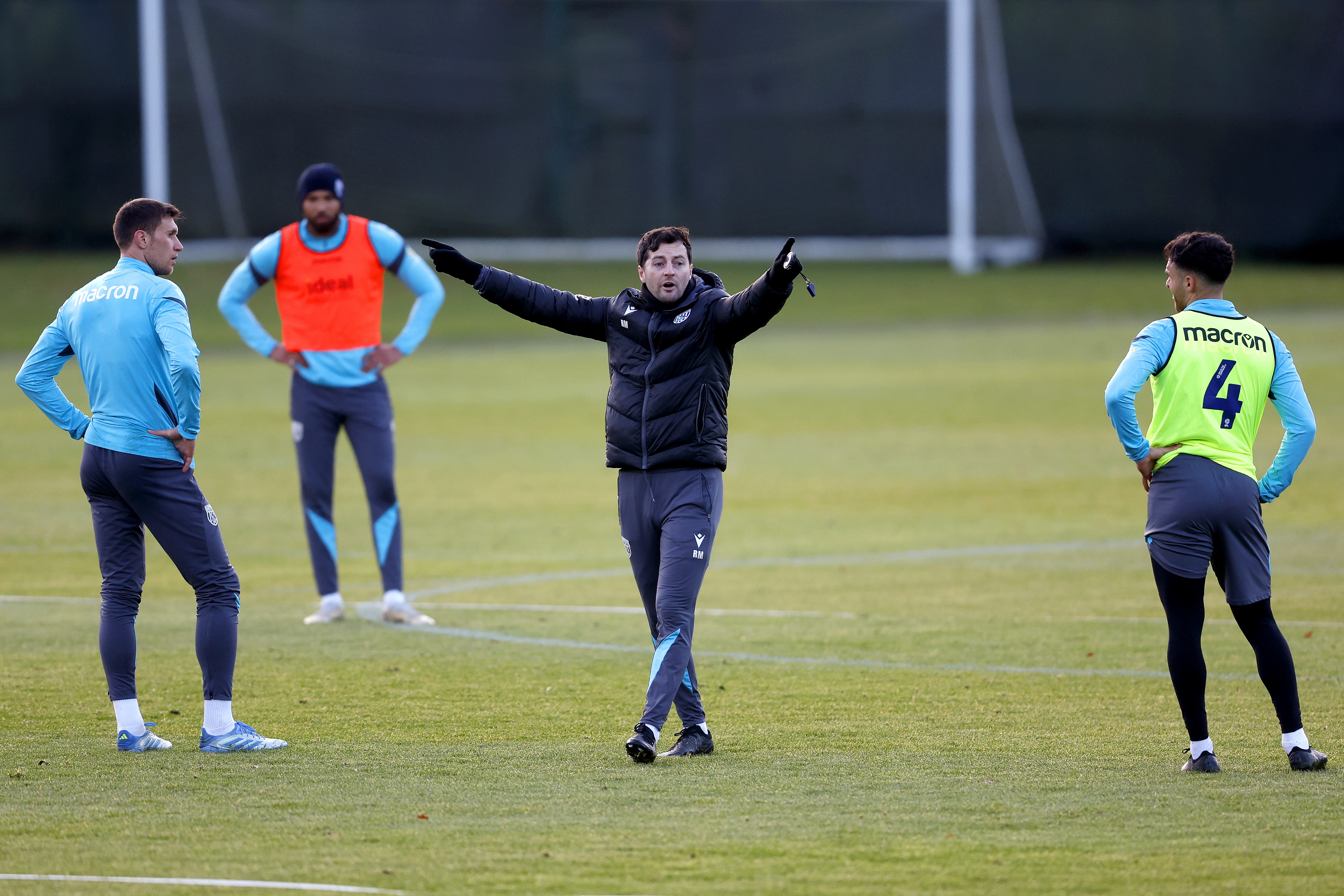 Ryan Mason delivering instructions to players on the training pitch 