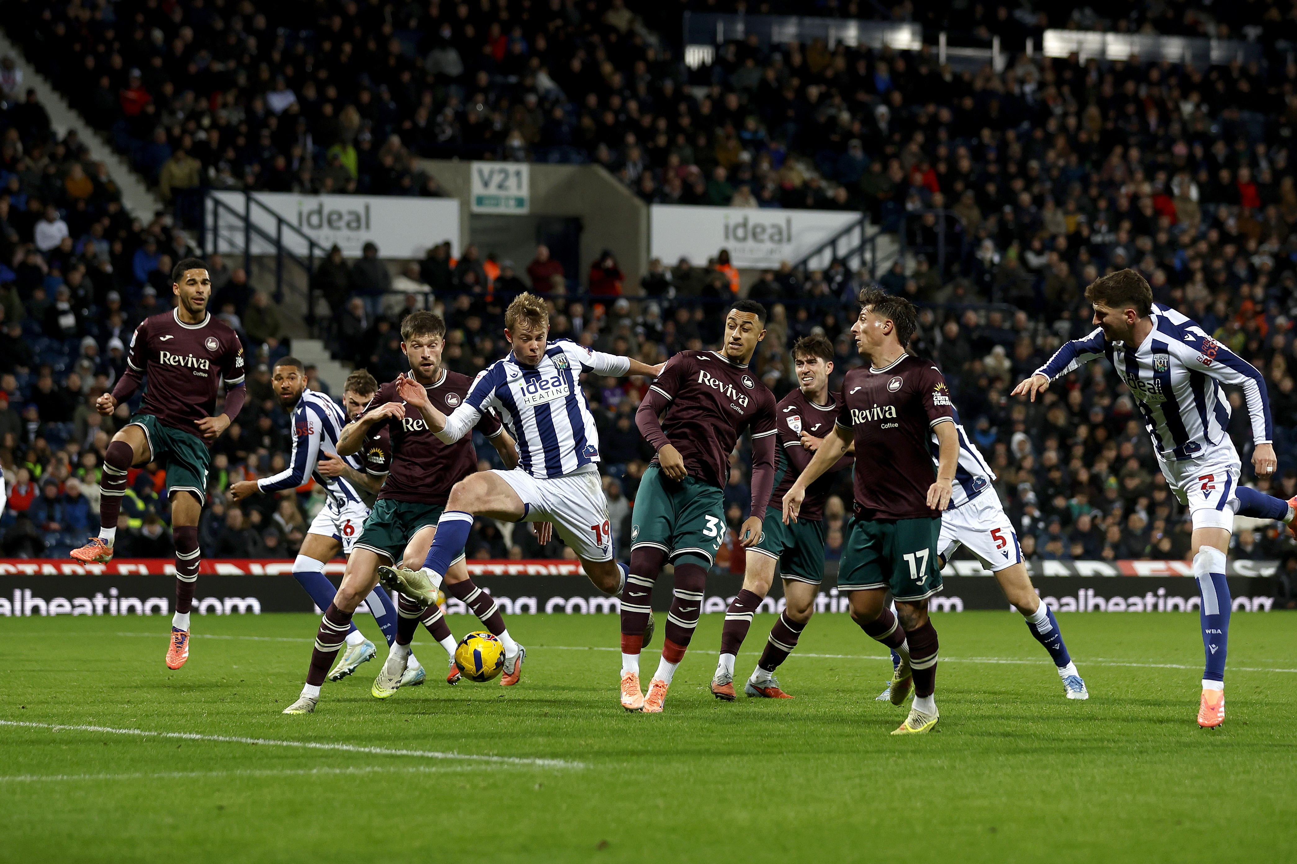 Plenty of players in the penalty area fight for the ball between WBA and Swansea 