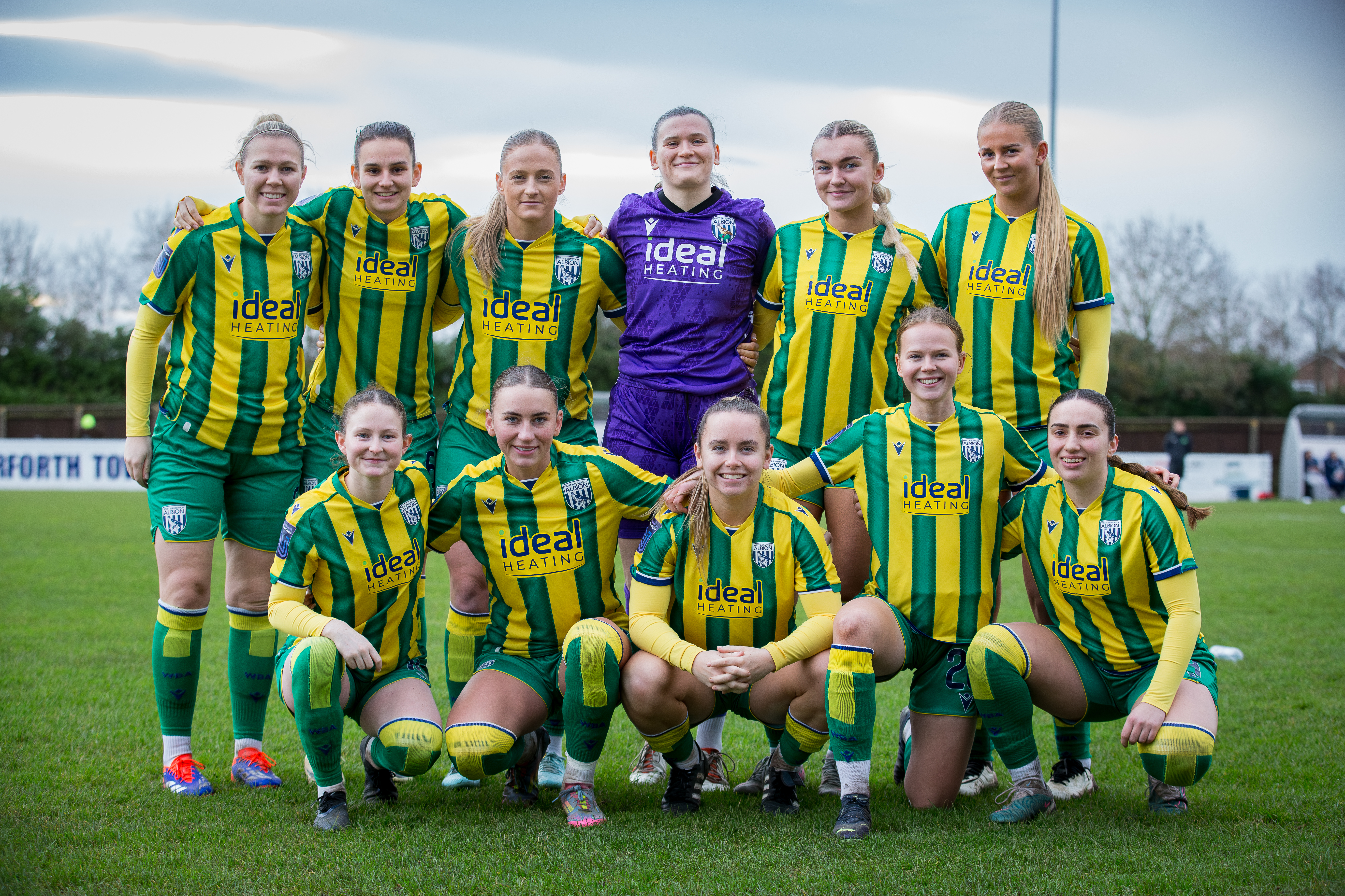 WBA Women team photo in green and yellow kit 