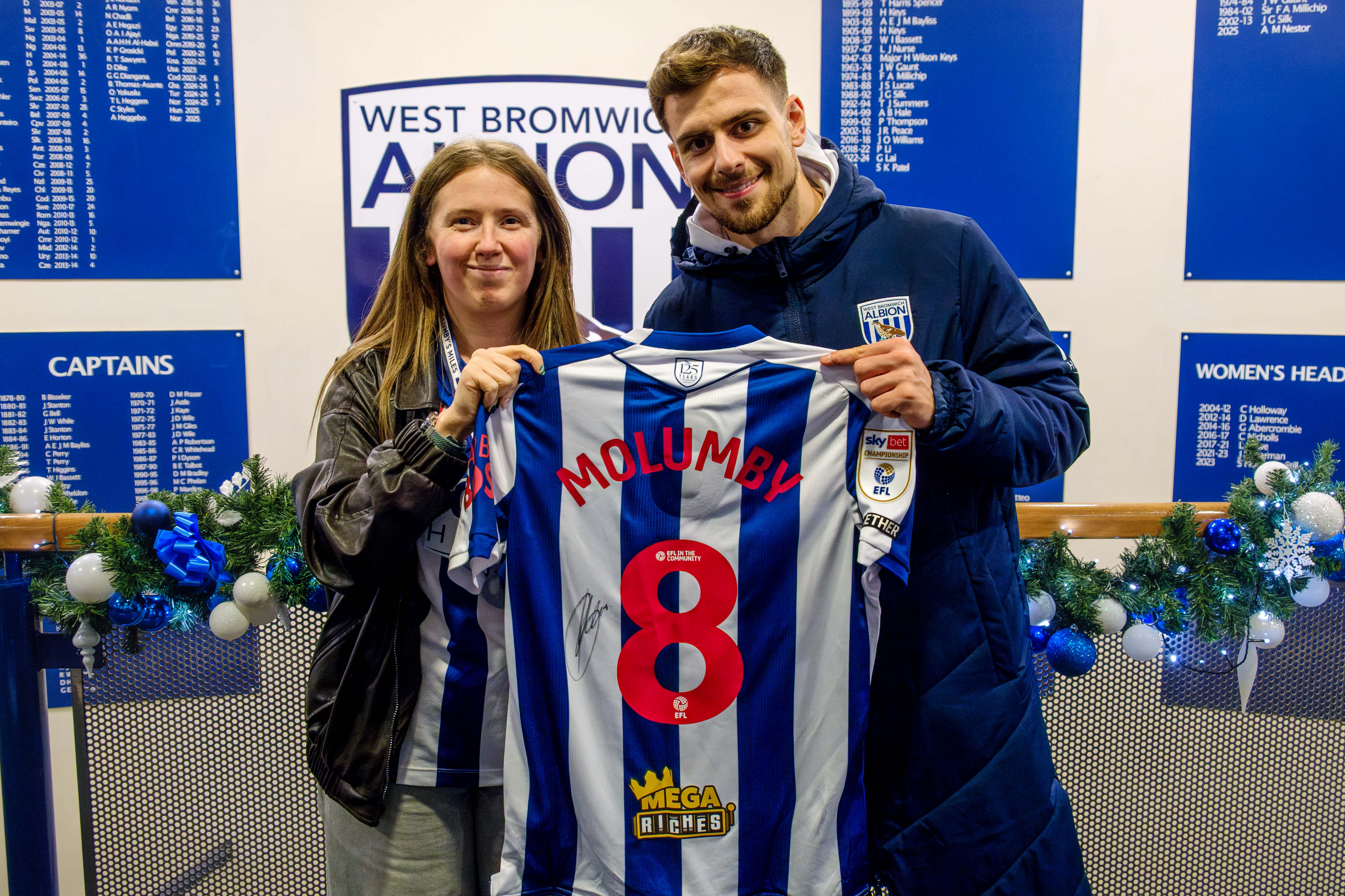 Jade Hopkins and Jayson Molumby holding his signed shirt inside The Hawthorns