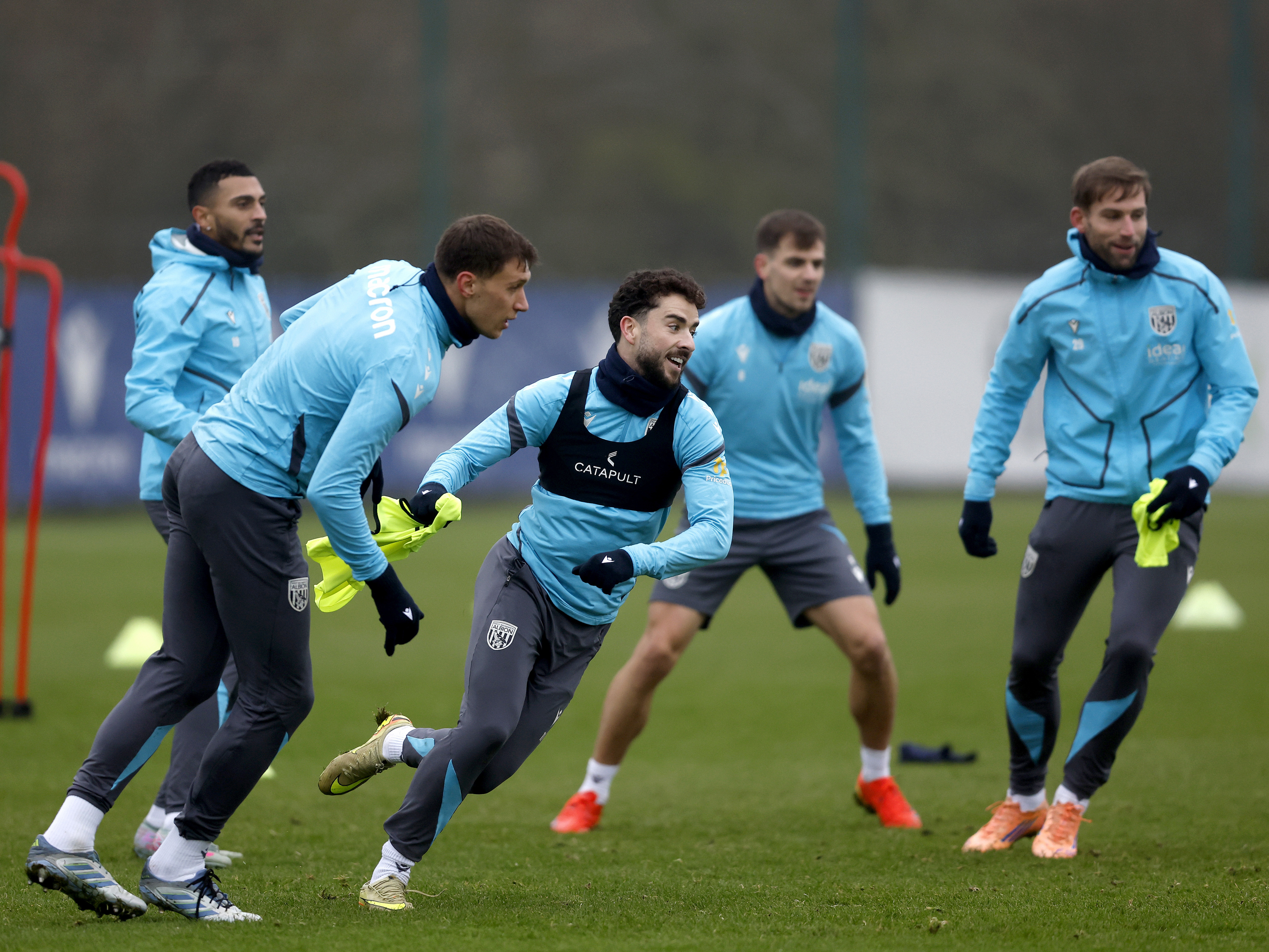 Five WBA players watching the ball in a small training drill 