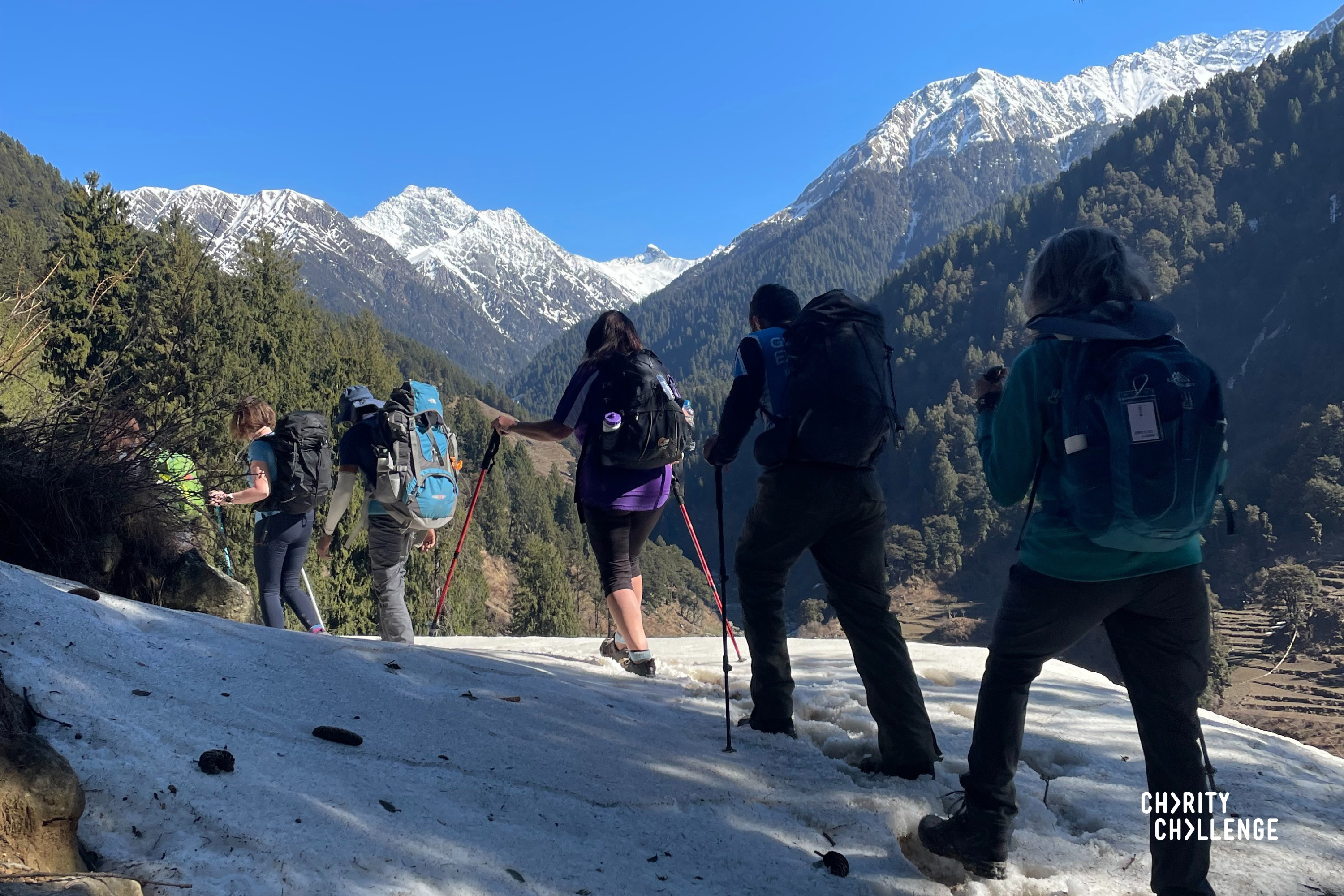 Trekkers walking along a mountain path.
