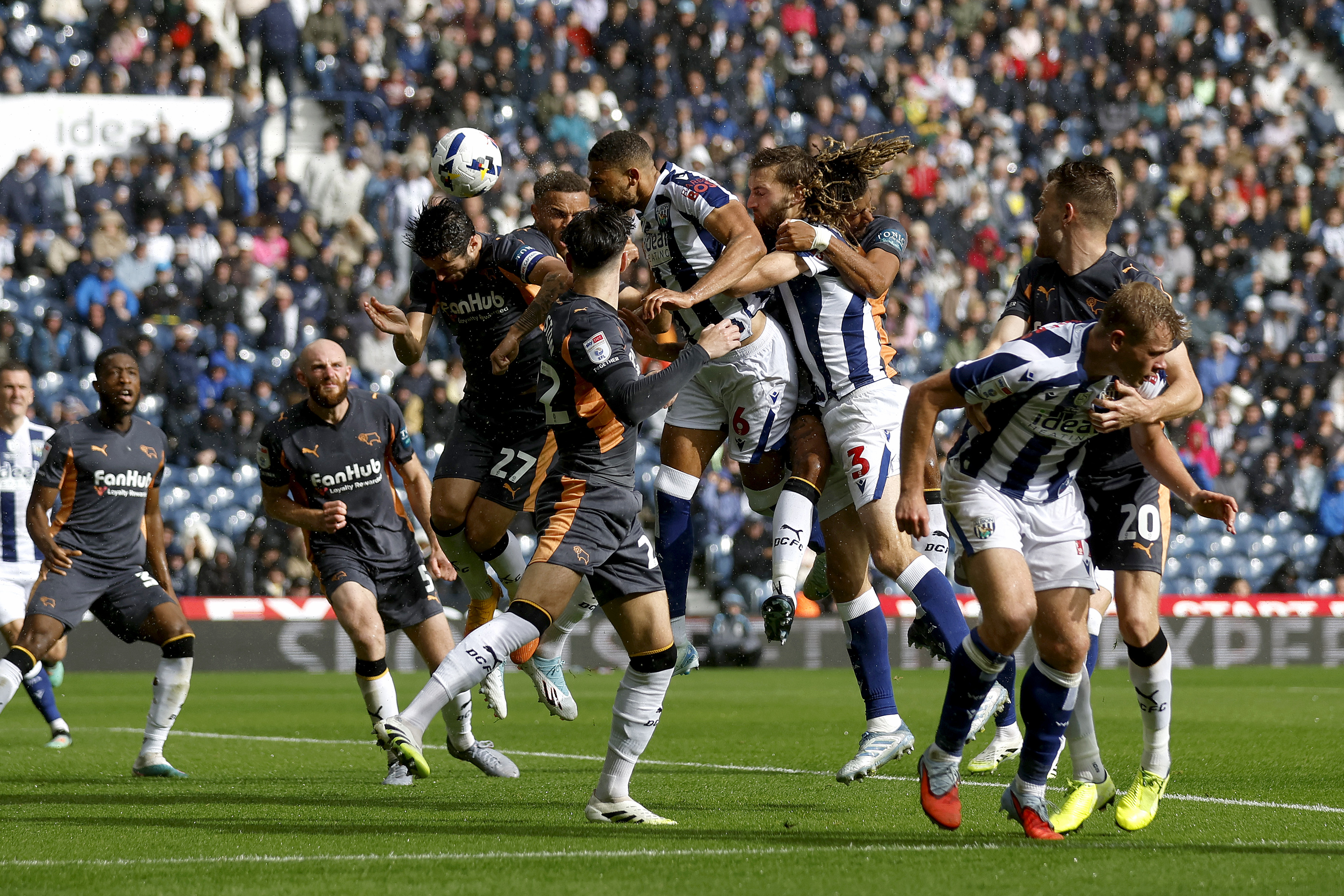 Several WBA and Derby players jump to try and win a header 