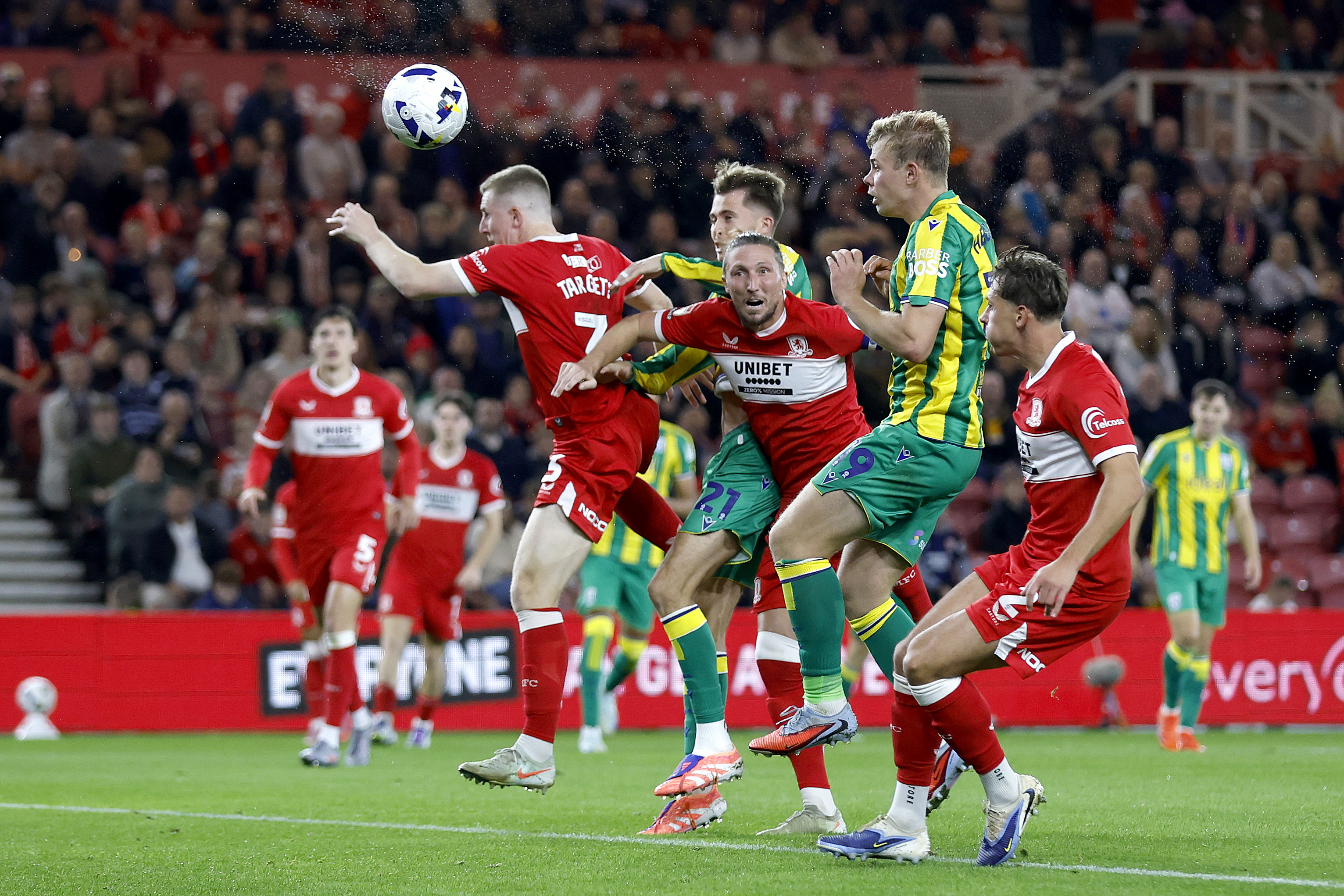Several Boro & WBA players jumping to try and win a header 