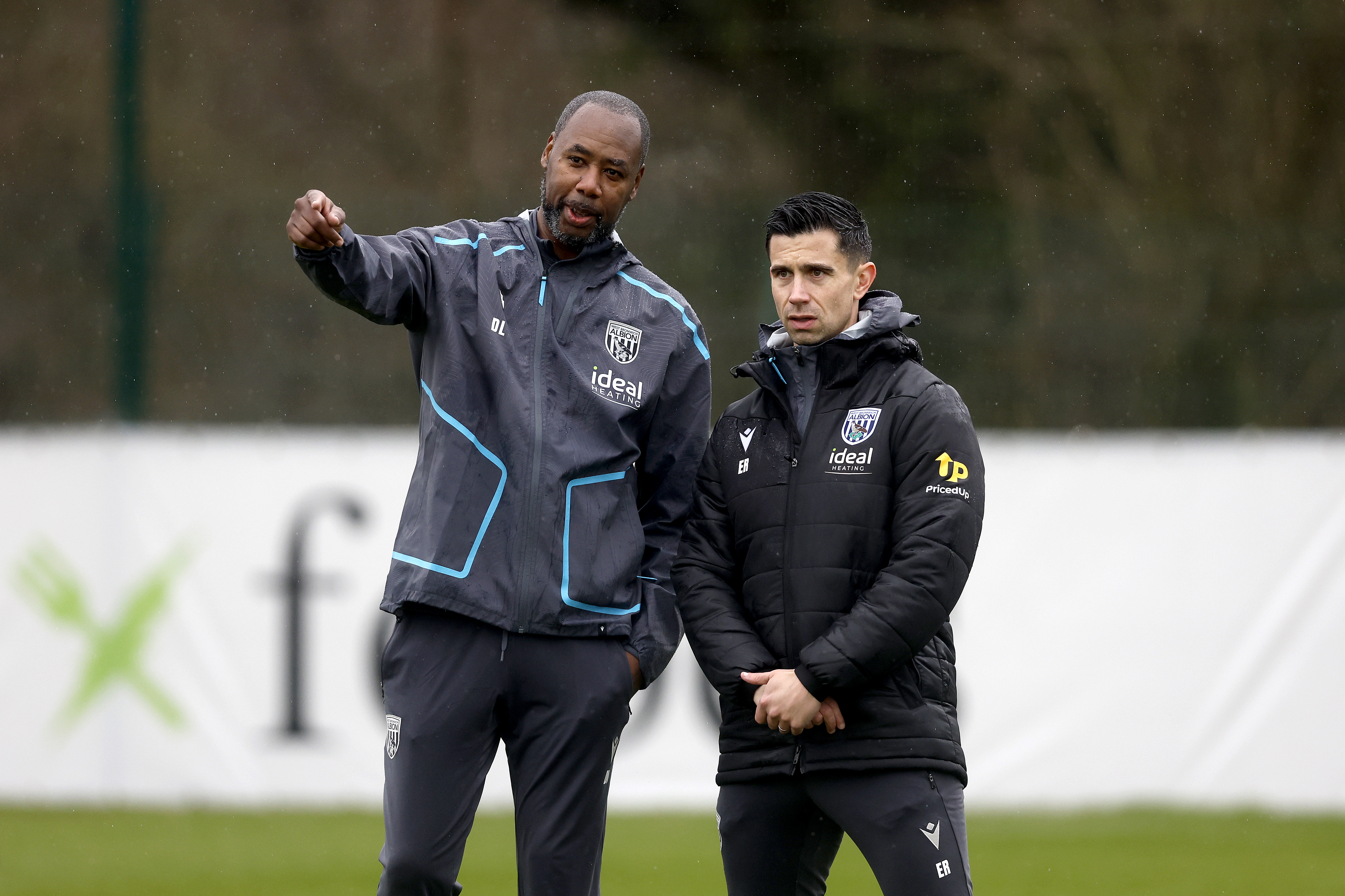 Dennis Lawrence talking to Eric Ramsay during a training session