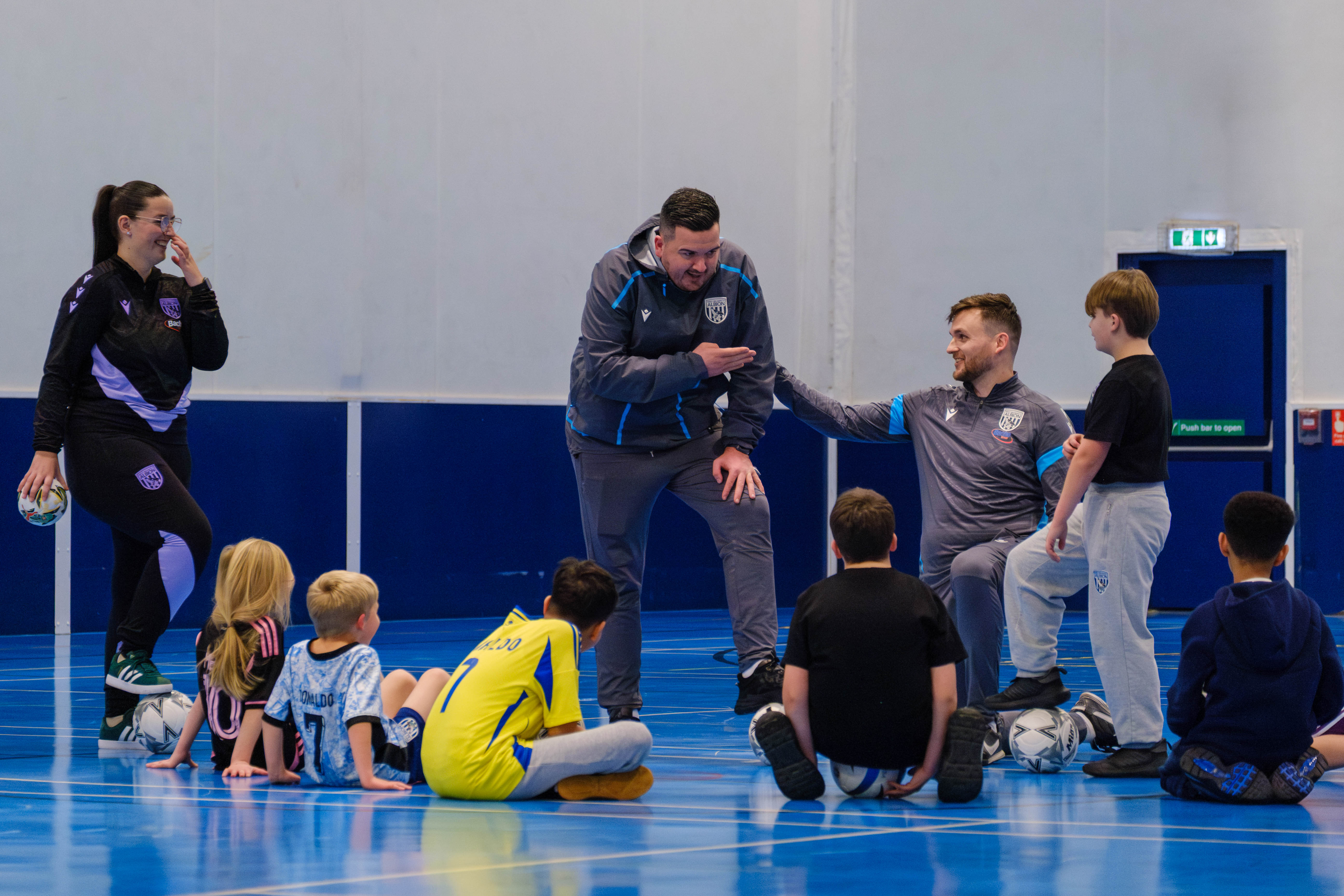 Participants gathered around as coaches discuss the session ahead